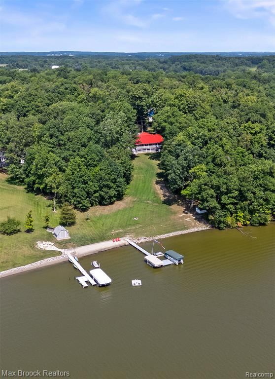 Escape to serene, upscale lakefront living in this completely remodeled contemporary log home, set on 10 wooded acres at Lake Diane. Boasting 3 bedrooms, 4 baths, and nearly 3,000 sq ft of exquisitely designed space, this residence was freshly transformed between 2017–2019 with a modern metal roof, updated systems, and luxury finishes throughout.

Step inside to soaring tongue-and-groove vaulted ceilings, light-filled living areas framed by walls of glass, and seamless access to a wraparound Trex deck overlooking the water. The gourmet kitchen features a custom quarter-sawn oak island, quartz countertops, and a charming farm sink—perfect for gatherings and culinary pursuits.

Enjoy effortless main-floor living with a spa-like primary suite while the lower level introduces additional versatility: a second kitchen, two en-suite bedrooms, recreation space, and full lake views from the walkout site. Outside, a sandy beach meets your private wooded paradise, with a pole barn and shed adding utility to the mix.

Rarely does a home so beautifully marry modern luxury with rustic lakeside charm—don’t miss this opportunity for year-round tranquility and entertaining at its finest