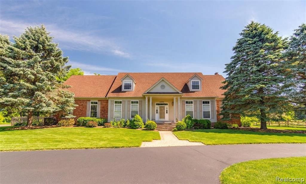 Welcome to 4090 Perryville, a stunning 4-bedroom, 4.1-bathroom family home nestled on a scenic 12.15-acre property in Groveland Twp. This exquisite estate offers the perfect blend of privacy, serenity, and modern luxury, with incredible features such as wooded trails, open land areas, and a private, nearly 2-acre pond stocked for fishing. Equestrian enthusiasts will fall in love with the 5-stall horse stable, tack room with power, and 3 horse pastures enclosed with an electrical fence. Additional amenities include a chicken coop, attached barn, above ground swimming pool. Inside, the main level boasts a large study with French doors and a coffered ceiling, a living room with a floor-to-ceiling brick mantle gas fireplace, and a dining room with a door wall leading to the breathtaking Florida room. The multi-tiered deck offers stunning views of the surrounding landscape. The gourmet eat-in kitchen features granite countertops, stainless steel appliances, cherry cabinets, and a breakfast bar. The first-floor primary bedroom offers a walk-in closet and en-suite bathroom with a double vanity, Euro-shower, and jetted tub. Two additional bedrooms, both with oversized walk-in closets, and a hall bath are found on the second level. The finished basement provides a cozy family room with a wood-burning stove, full-size windows, French doors, a rec room, fourth bedroom, full bath, and workspace. A circular driveway and 4-car attached garage complete this exceptional property, with stairs leading to a 13x30 bonus room equipped with a 220v hookup. Enjoy peace of mind with the included whole house generator. Don't miss this unique opportunity to own a magnificent family home in a picturesque setting - schedule a showing today! Price is firm - No negotiations.