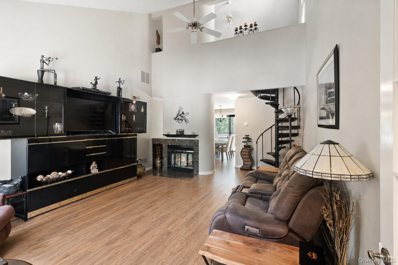 This value-packed, move-in-ready upper-level condominium lives like a two-bedroom, located at the end of a cul-de-sac in Oakridge Condominiums, Vista, NY. Offering approximately 1,312 sq ft, this residence includes a vaulted loft and a bonus rooms. This home provides a flexible living space ideal for a home office, den, exercise room, hobby area, or additional storage. This south-facing home features a landscaped garden area with two shade trees. Enter through the French door into the living room with engineered wood flooring, cathedral ceiling, and a wood-burning fireplace. The dining area and kitchen feature sliding glass door access to a deck with wooded views. The kitchen features tile flooring, beveled countertops, maple cabinetry, and stainless-steel appliances. Off the dining area is a hallway with a full-size washer/dryer closet, a linen closet, and a ceramic tiled bathroom. The primary bedroom features a cathedral ceiling, double-tier closet, and mirrored wardrobe/storage wall unit. An additional main-level room offers flexible use for office, den, fitness, or hobby space. Recent updates include a newly installed HVAC system (2026 heat pump and air handler) and a new 40-gallon hot water heater (2025). Interior walls and ceilings were professionally painted in 2023. Additional improvements include upgraded window treatments, interior doors, Andersen front windows, and ceiling fans in the living room, primary bedroom, and loft. Located in the desirable Oakridge Condominiums community in Vista, New York, with convenient access to shopping, commuter routes, and nearby amenities. Community amenities include three pools, two tennis courts, and a basketball area.