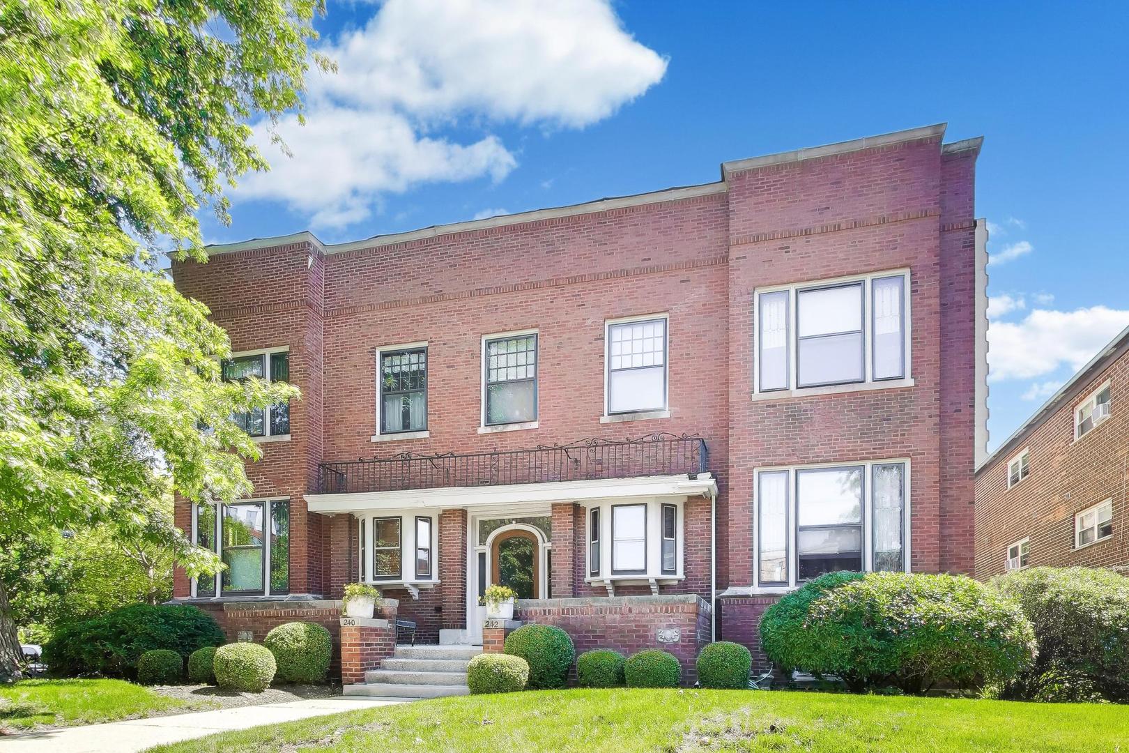 Rarely does a classic home of this caliber come to market. Welcome to this breathtaking 3-bedroom, 2-bathroom, first-floor, vintage -duplex down condominium situated in a boutique, 4-unit, brick building in the heart of historic Oak Park. Spanning an impressive 2,166 square feet of sublime living space, this residence features a highly flexible floor plan that offers a multitude of lifestyle options while retaining its irreplaceable historic charm.  The expansive main level living room is a showstopper, featuring magnificent coffered ceilings, a cozy fireplace, and sweeping, picturesque views of Mills Park. This stunning space opens onto your own private elevated terrace and lush backyard-making it an entertainer's dream. The space connects beautifully with the dining area and updated chef's kitchen, which features premium porcelain and honed granite countertops paired with top-tier stainless steel appliances, including a Bosch dishwasher, JennAir range, and a Samsung refrigerator.   The incredible primary suite serves as a private, standalone retreat. It features a dedicated sitting area anchored by a second magnificent fireplace and is enveloped in classic Craftsman details, including a continuous picture rail and custom built-in quarter-sawn oak bookcases flanking a gorgeous mantle. The fireplace itself is a work of art, framed by stunning stained art glass windows and adorned with historic green relief tiles depicting whimsical scenes of children at play.  The main-floor bathroom has been beautifully modernized with a high-end vintage aesthetic. Included are a classic console sink on a polished chrome stand, an elegant glass-enclosed walk-in shower lined with floor-to-ceiling white subway tile, a striking herringbone tile shower floor, and timeless oil-rubbed bronze door hardware that honors the home's historic roots.  The lower level provides ultimate versatility, offering incredible options for custom configuration. Perfect as an expansive family room, private guest quarters, or an in-law suite, this fully finished area includes a third fireplace, a convenient dining nook, and a well-equipped kitchenette. This level features a private, comfortable bedroom complete with a deep-set window bringing in natural light, and an unexpectedly large walk-in closet providing exceptional storage. A second full bathroom-tastefully finished with crisp white beadboard wainscoting, a modern floating vanity, and a glass-enclosed shower-completes this lower level.  Additional features include central air conditioning, garage parking, and three distinct exterior spaces. Nestled in Oak Park's highly sought-after Pleasant District, you are just steps away from vibrant cafes, renowned restaurants, the Green Line, Metra, and the historic grounds of Mills Park. Don't miss the chance to own an architectural gem with unmatched space and adaptability!  The home is in exceptional condition but being offered in as-is condition.
