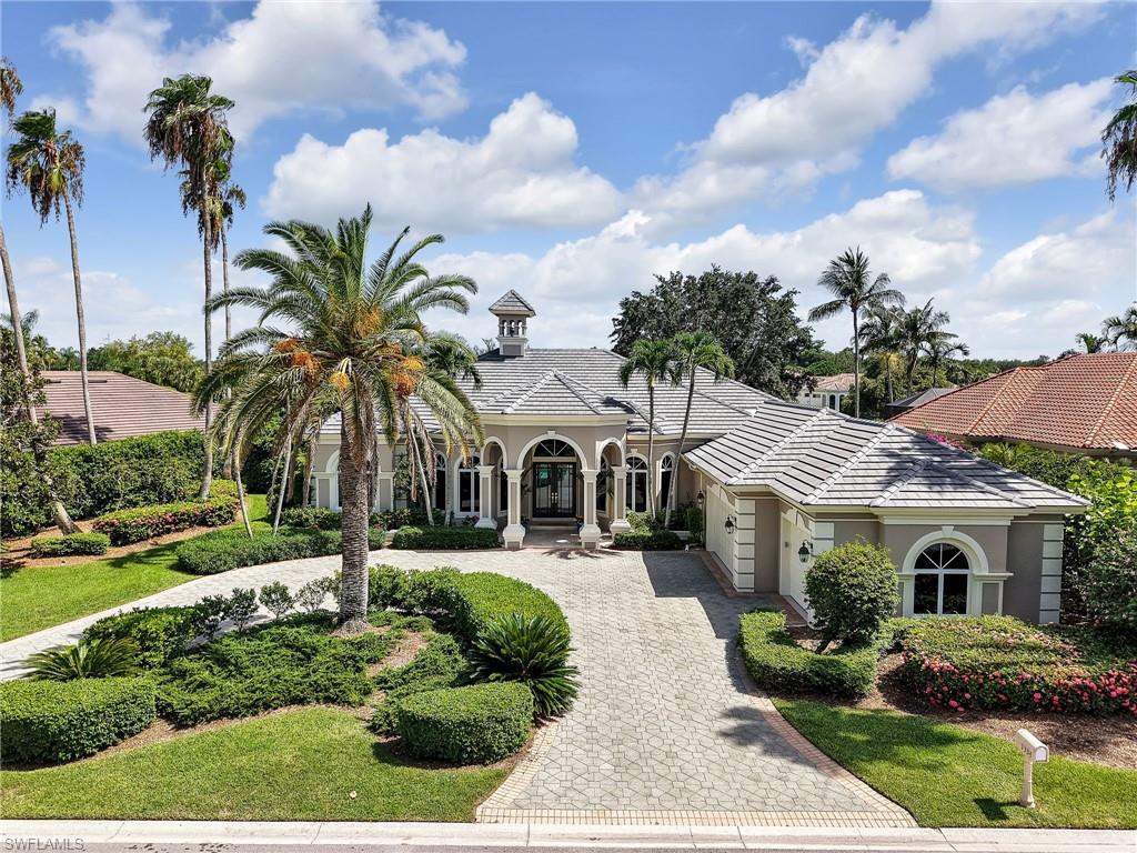 One or more photo(s) has been virtually staged, AI generated or rendered.  Rarely available in the Arbors at Pelican Marsh, an intimate enclave of estate homes inside one of North Naples' premier gated golf communities, where homes seldom reach the market. This beautifully maintained four bedroom plus den residence offers nearly 3,800 square feet of living space on a private .46 acre homesite with breathtaking southwest facing lake and golf course views.Every bedroom includes its own private en suite bathroom, with one serving as a convenient pool bath. The private den, complete with a closet, flexes easily into a home office or fifth bedroom. The expansive screened lanai features a heated pool and spa positioned to capture sunset exposure over the lake and fairways, true indoor outdoor Florida living made for entertaining.Recent improvements include a new tile roof (November 2024), fresh interior and exterior paint, updated door hardware, and new light fixtures throughout much of the home. Inside you will find custom woodwork, decorative tray ceilings with crown molding, soaring volume ceilings, French doors, and a rare wood burning fireplace.The spacious kitchen is built for gathering: warm wood cabinetry, center island, tile backsplash, breakfast bar, pantry, and abundant counter space. The oversized primary suite offers a sitting area and a luxurious bath with dual vanities, jetted soaking tub, bidet, and separate shower. Additional highlights include a circular driveway, an oversized three car garage, a dedicated air conditioned storage room, and a spacious laundry room with upper and lower cabinetry. Select photos are virtually staged.Pelican Marsh is a gated North Naples community just 1.5 miles from Gulf beaches and Vanderbilt Beach, minutes to Mercato, Waterside Shops, Artis Naples, and exceptional dining. Residents enjoy over 130 acres of nature preserves, miles of walking and biking trails, tennis, pickleball, bocce, a state of the art fitness center, spa services, and optional membership to the private Pelican Marsh Golf Club. Please use the entrances to neighborhood off of Airport Pulling and Vanderbilt Beach only for now. The Tamiami/US 41 entrance is being redone. This would be the normal entrance used for this home and location within the community.