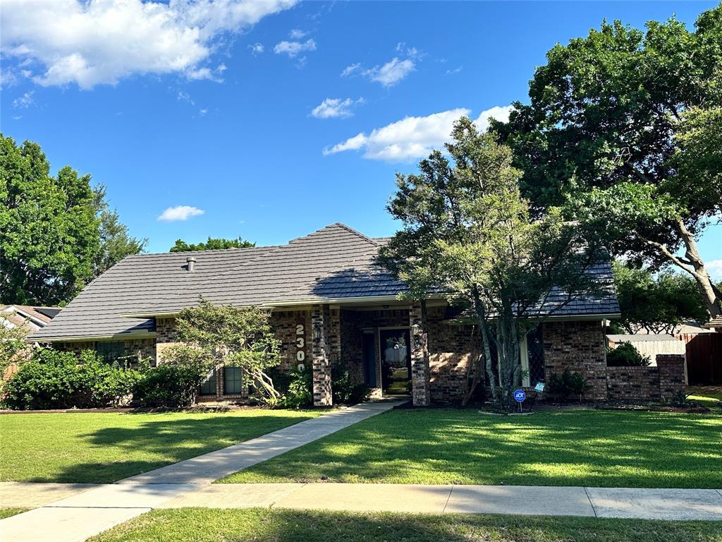 **Priced Below Market** Discover this beautiful home featuring recent wood-look flooring and neutral interior paint. Enjoy a modern kitchen with granite counters and a travertine backsplash, along with contemporary light fixtures and hardware. The spacious layout includes four large bedrooms and updated bathrooms; the primary bath boasts his and her vanities and closets. All popcorn ceilings have been removed and retextured for a clean look. Step outside to a private backyard with a covered outdoor living area, relax in the refreshing pool and heated spa year-round. Plus, artificial turf around the pool means no mowing required. With a lifetime roof, you’ll save on insurance. Conveniently located near 121, 75, George Bush Turnpike, Legacy Business Park, Firewheel and plenty of shopping and dining options.