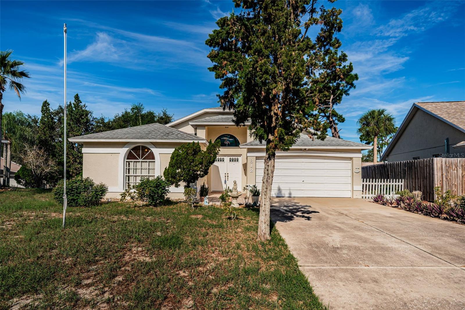 CUL DE SAC ~ NO FLOOD ZONE ~ EXCELLENT LOCATION. Must see an affordable home located in the heart of Tarpon Springs. This GREAT ROOM floor plan offers 1423 sqft of open living space featuring 3 bedrooms, 2 bathrooms, a desirable split-bedroom floor plan designed for both privacy and functionality with a 2 car garage located on an .21 acre cul-de-sac lot. The double front door entry invites you into the ceramic tile foyer. The great room features soaring cathedral ceilings and flows nicely into the kitchen and dining area - perfect for entertaining family and friends. The functional kitchen overlooks the backyard with easy access to the outdoor Florida room and backyard patio with easy access to your dining area. The secondary bedrooms are located in the front of the home with easy access to the guest bathroom featuring a tub/shower combination. The spacious primary suite is privately tucked away at the back of the home with a private bath featuring a walk-in shower, spacious vanity with a new sink and a large walk-in closet. The enclosed Florida room has a nice added living space and does have an air conditioning vent but is not included in the heated and air conditioner square footage of 1423. The two car garage is attached with the laundry facilities along with a garage service door to the backyard ideal for gardening enthusiasts and or pets. Additional features of this home include a newer HVAC (2021), water heater (2019), a 30 year shingle roof was put on in 2009, LOW  annual HOA fees, NO CDDS fees and NO FLOOD INSURANCE REQUIRED. Brittany Park is an wonderful place to live conveniently located to Historic downtown Tarpon Springs, the famous Tarpon Springs sponge docks,  restaurants, Fred Howard Park and Sunset Beach plus more award winning beaches, golf courses, shopping, medical facilities, the Pinellas County Trail for all your biking and exercising needs and so much more. This is truly a MUST SEE home. It is affordable, in an amazing location, and definitely a place you will want to see and call home.