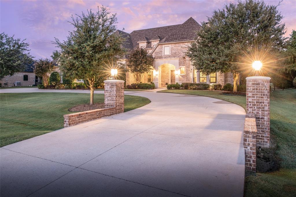 Welcome to this exquisite custom estate in coveted Lovejoy ISD! This breathtaking single-story custom home was built by renowned builder Cleve Adamson. Set on a 1-acre lot with unmatched craftsmanship and design. The beautiful curb appeal with circular drive and stately façade set the tone for this luxurious retreat. Step inside to soaring 12-foot ceilings with wood beams, open-concept living, and elegant designer finishes throughout.The chef’s kitchen is a true showpiece featuring a massive single-slab quartzite island, double electric ovens, pot filler, double-door built-in refrigerator, and a seamless flow into the dining, breakfast, and living spaces—all overlooking the backyard oasis. Relax and entertain outdoors with a gorgeous outdoor kitchen and the recently updated pool, expansive covered patio, gas-log fireplace, and motorized screens for year-round comfort. Work from home in the stunning office, complete with oversized glass French doors, ceiling speakers, and a private courtyard surrounded by brick and wrought iron. Guest quarters is split from secondary bedrooms closet is equipped as a safe room! Remaining 3 bedrooms are on the opposite end of the home. All rooms are have ensuite bathrooms. One bedroom is currently decked out as a gym. Car enthusiasts will fall in love with the 5-car garage complex, including a 1,500 sq ft heated and cooled garage designed with every detail in mind some details are: 12’ ceilings to accommodate lifts, copper piping for air distribution with 5 outlets and 2 hose reels, 2 industrial 240V outlets, commercial divider curtain, 2000-lb crane access to the “Texas Basement”, Epoxy-coated floors, electrical reels, ceiling speakers, and abundant storage. Additional highlights include whole-home spray foam insulation and a generator. This is more than a home — it’s a masterpiece of design, functionality, and luxury living in one of Fairview’s most desirable neighborhoods. 
Additional features list available on MLS and upon request