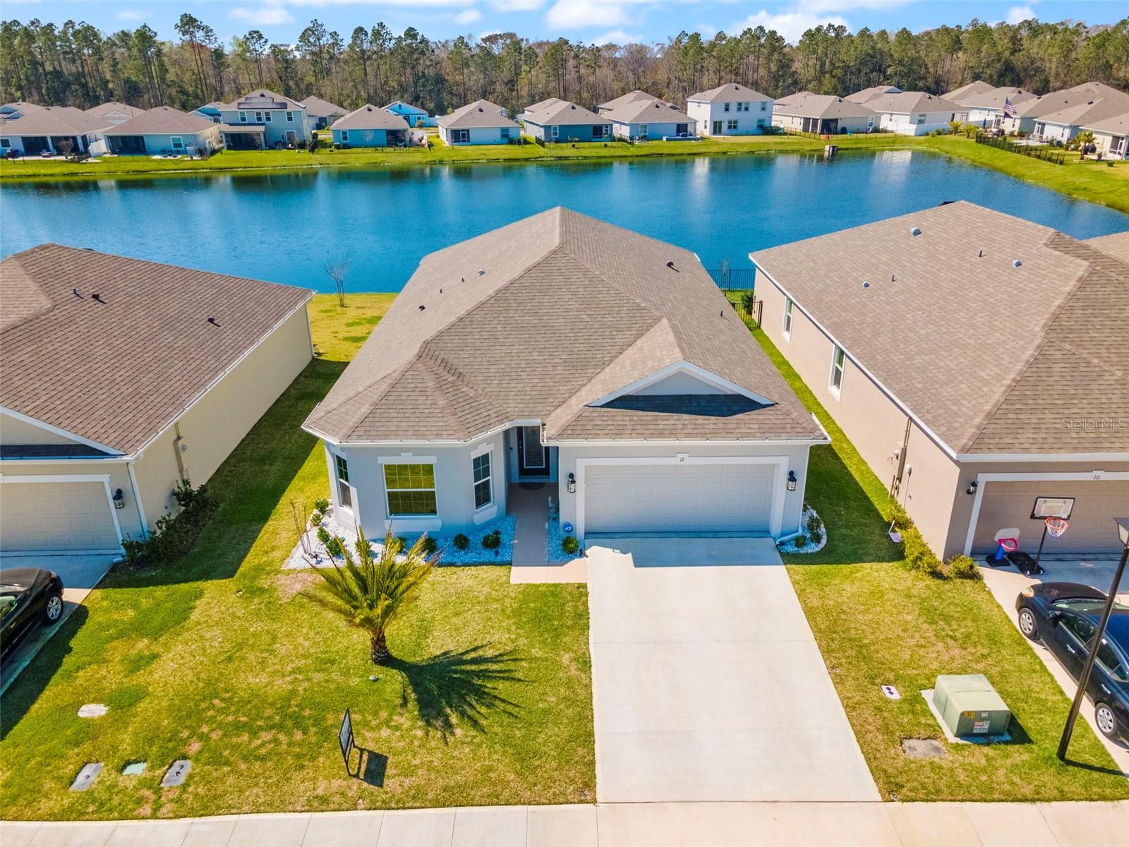 LENDER CREDIT OPPORTUNITY! Qualified buyers may receive a significant lender credit at closing through a preferred lending program. 

Welcome to 12 Ridge Road in beautiful Palm Coast, FL! 

This impeccably upgraded home offers 2003 square feet of air-conditioned living space designed for both comfort and functionality. Barely lived in and meticulously maintained—less than 2 years old—this move-in-ready property is the epitome of modern luxury.

The residence features three spacious bedrooms plus an office with a closet, providing the flexibility to convert it into a fourth bedroom if desired. Step into an open, light-filled floor plan where modern details abound. The main living areas showcase upgraded luxury vinyl plank (LVP) flooring, while ceiling fans throughout add to the airy ambiance.

The gourmet kitchen is a chef’s delight, boasting upgraded cabinet hardware with pullouts in all lower cabinets and an upgraded refrigerator that perfectly complements the space. Two well-appointed bathrooms ensure convenience, with the guest bathroom offering direct access to an extended, screened lanai—ideal for relaxing or entertaining.

Enjoy serene pond views from the beautifully landscaped backyard, enhanced by mature palm trees. The home also features an upgraded glass front door, window tint in the master bedroom, additional living room and backside guest room windows, and upgraded gutters for added peace of mind.

Practical touches include a two-car garage, convenient sidewalks, and a nearby street light to brighten your evenings. Plus, the property comes with a termite bond, ensuring a worry-free living experience.

Don’t miss the opportunity to call this exceptional, move-in-ready oasis your new home!