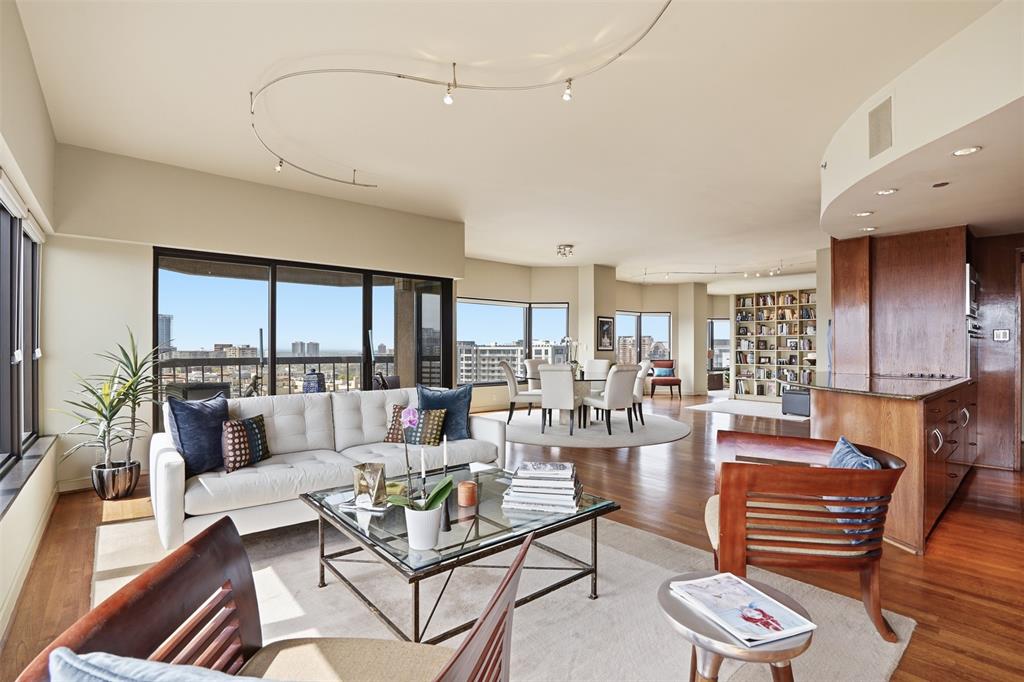 Elevated on the 16th floor of the iconic La Tour, this 3,126-square-foot double residence breaks the mold of standard high-rise living. By merging two units into one cohesive, L-shaped floor plan, designers Marco French and Ike Eisenhower created a space that feels more like a sprawling estate in the sky than a traditional condo. Perimeter walkways wrap around the home, ensuring that the 270+ degree views—stretching from the iconic Downtown skyline and Fair Park to North Dallas—are always the focal point.The layout is intentionally split into two distinct wings to balance high-end entertaining with total privacy. Wing one is built for hosting, featuring an expansive living and dining area, full kitchen, guest suite, library, and a flexible executive office that easily converts into a third bedroom. On the other side, wing two is a dedicated retreat, anchored by a massive primary suite with a spa-inspired bathroom and dual ELFA closets. It also houses a refined media lounge equipped with a full bar, wine fridge, and ice machine—perfect for late-night movies or a quiet drink.  The tech and perks here are just as impressive as the views. The home is outfitted with Grafik Eye lighting, a 12-speaker Sonos system, and Hunter Douglas shades. Rare for Uptown, the property includes four parking spaces, two storage units, and two board votes.Living at La Tour means more than just a great view; it’s a full-service lifestyle. You’re steps away from the Katy Trail and the best dining in Uptown, but you also have a resort-style pool, a fully equipped gym with saunas, tennis and pickleball courts, and a private dog park right at home. With 24-hour concierge, valet, and a long-tenured staff handling everything from security to packages, the experience is entirely effortless. Whether you’re throwing a party against a backdrop of city lights or disappearing into your private wing, this is a level of space and security that’s hard to find anywhere else in the city.
