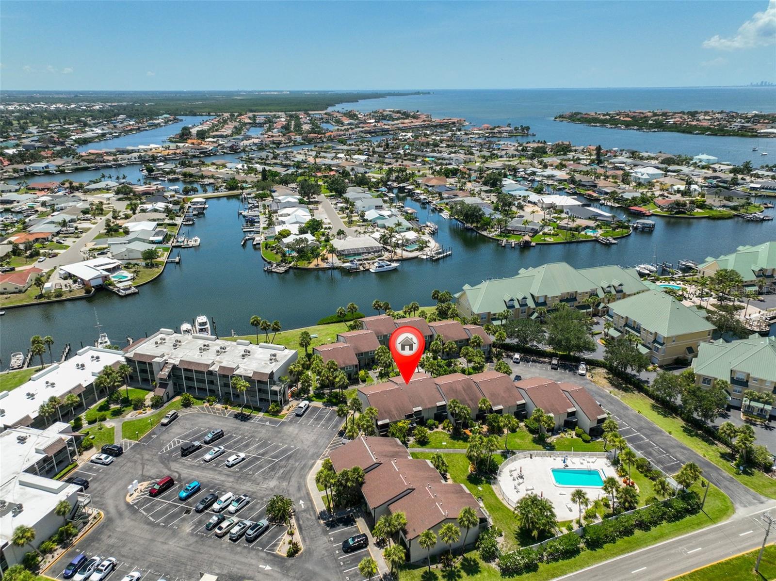 The waterfront community of Anchor Point has a lovely 2 bedroom, 2 bathroom fully furnished turn key townhouse style condo unit for sale. This is the perfect unit to call home, use as a second home or as an investment for monthly rental.  The unit has been updated with easy care wood look ceramic plank tile throughout the first floor.  New shaker style white cabinet, granite countertops, white subway tile backsplash and pots, pans, dishes, utensils, and appliances make the kitchen bright and efficient.  There is a large pantry and extra storage under the stairs.  The kitchen leads to the comfortable dining and living area and cozy screened lanai with outside storage. The 2 bedrooms featuring a primary suite with a walk in closet, full bathroom, and a private balcony, an additional bathroom and a laundry closet with a full sized washer and dryer and linen closet complete the upstairs. 
Cool off with steps to the community pool or gather with friends in the community center with indoor and outdoor spaces available. Sit by the water and check out the dolphins and other sea life.
Docks are available for $170/month.  (Best bargain around!)
