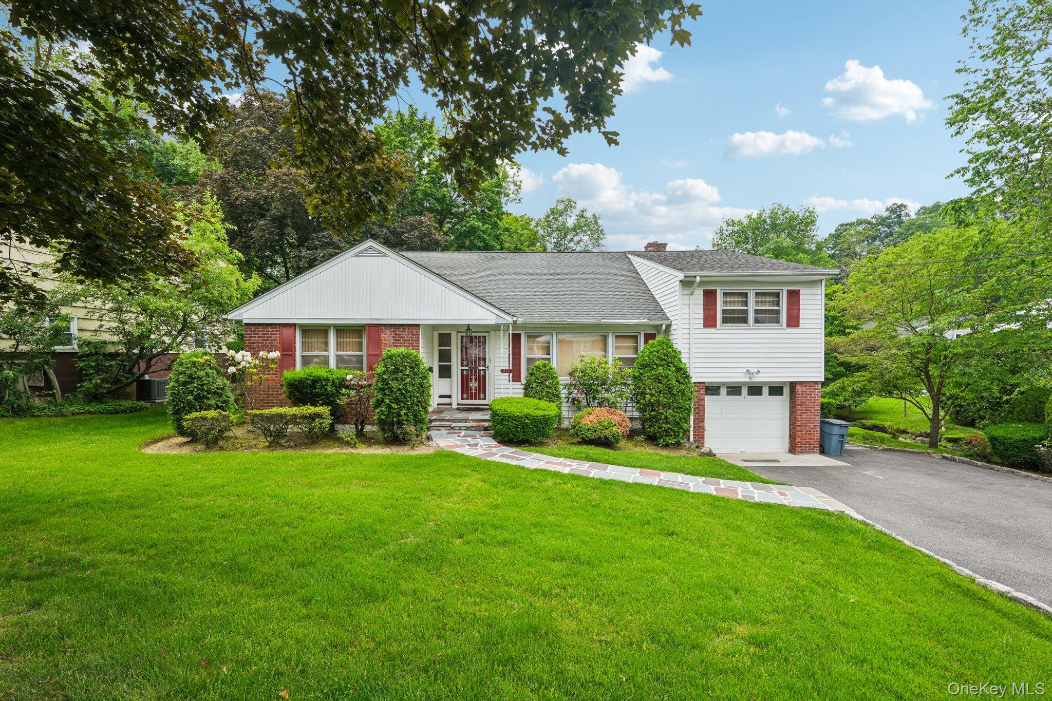Discover this delightful split-level home situated on a tranquil, tree-lined street. Boasting four generously sized bedrooms and three full bathrooms, it offers ample space and comfort. Beneath the carpeting lies original hardwood flooring, untouched for four decades. The walk-out basement provides access to a screened-in back porch with views of the lovely grounds, plus a private entrance and full bathroom ideal for extended family. A little updating and personal flair will transform this house into your dream home. Adding to the charm, a brook runs alongside the property, occasionally visited by snapping turtles, ducks, swans, and a crane—remember, please do not feed the ducks! The location is superb, with schools, highways, restaurants, shopping, and the Metro North train station all within easy reach. Yonkers has school choice by ballots.