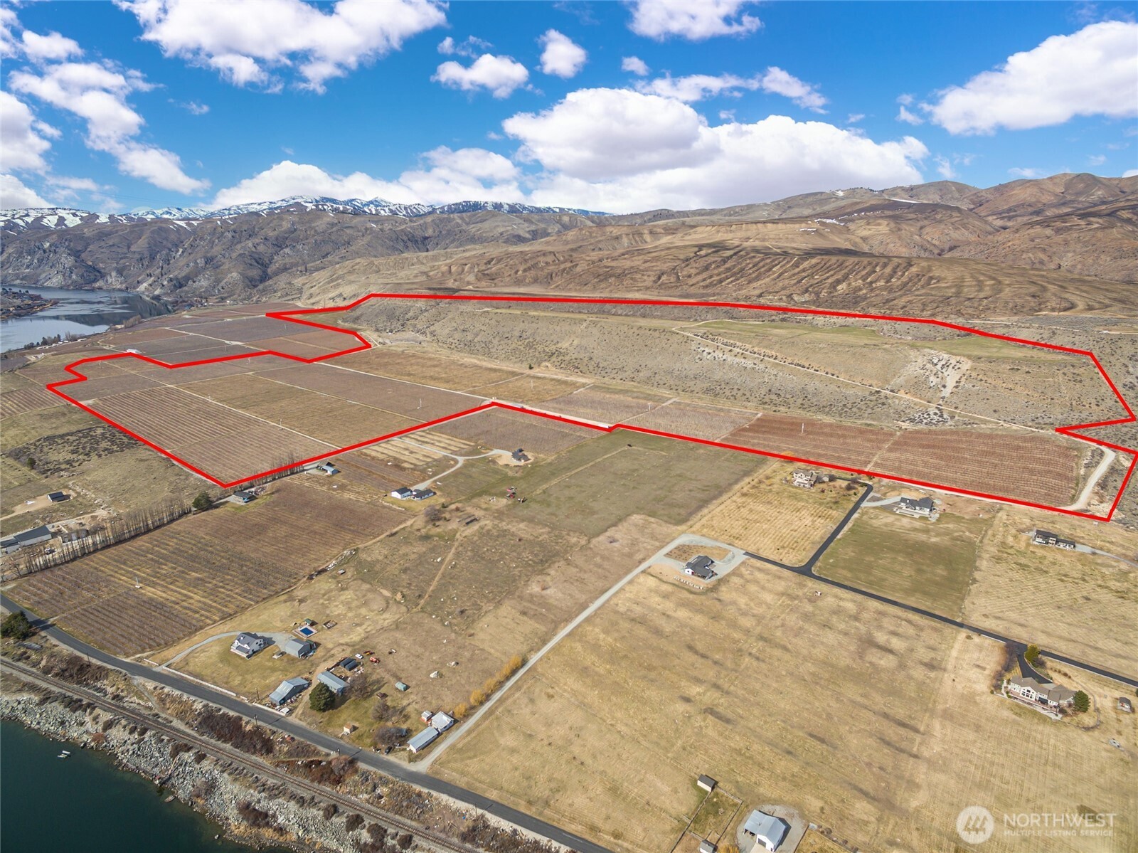 This 250-acre piece of pristine farmland is nestled between Lake Chelan and the Columbia River, offering stunning river and mountain views in a peaceful country setting, yet just minutes from Chelan. Sale includes 15 separate tax parcels. Currently planted with a variety of fruit trees, including apples, cherries, grapes, pears, and a small area of alfalfa. Irrigation water rights available. Continue farming the land or take advantage of this rare opportunity to build your dream estate. There's even space for small runway if desired. Whether you're looking to create a world-class equestrian facility, destination event venue, large private estate, or something else entirely, this location is perfect for bringing your vision to life.