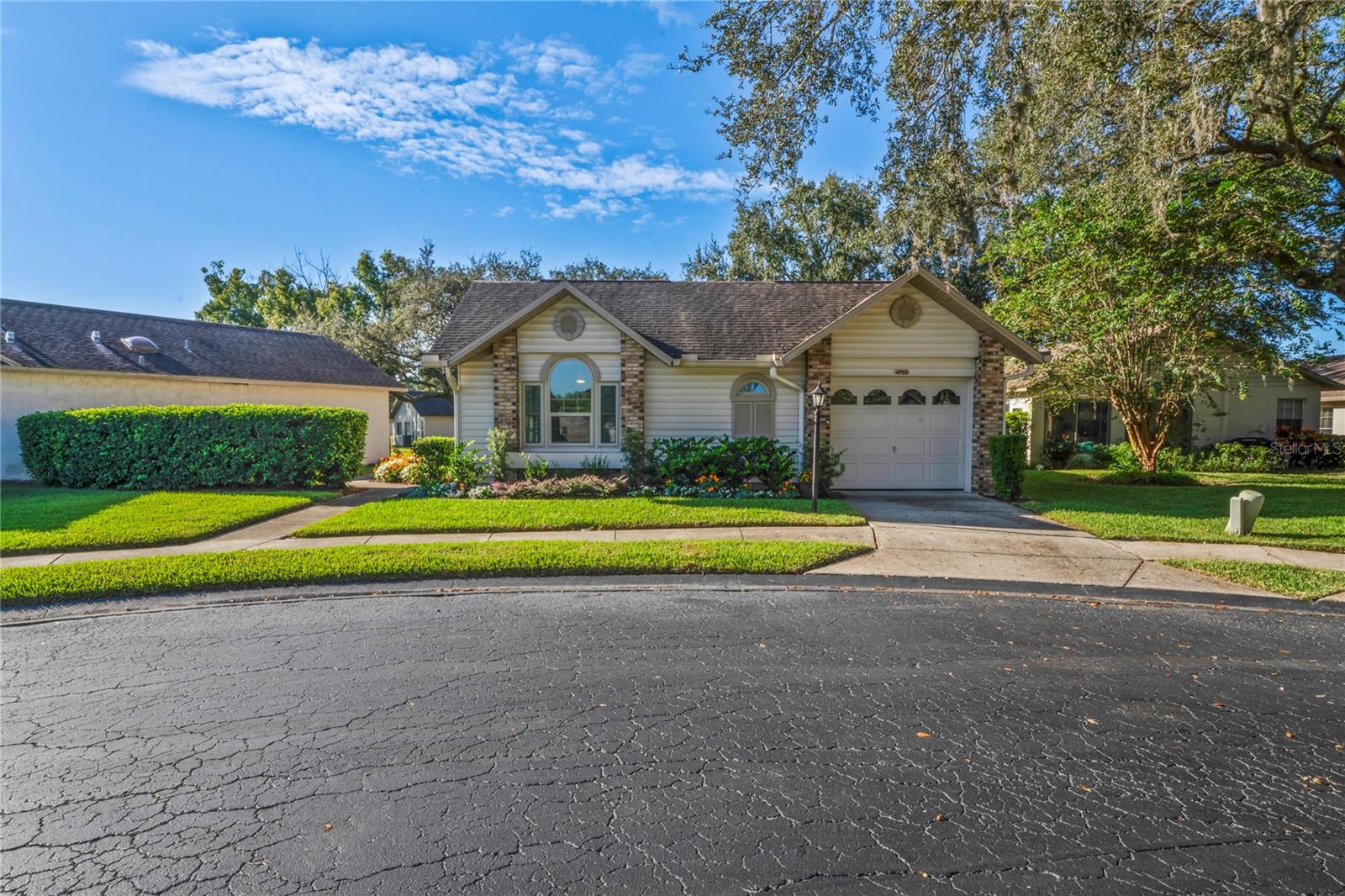 Move-In Ready 2 Bedroom, 2 Bathroom Villa with Garage in Heritage Lake’s Cedarwood II Village!
Beautifully updated and move-in ready, this 2BR/2BA villa with a one-car garage is located in the highly desirable 55+ community of Heritage Lake (Cedarwood II Village). From the moment you arrive, you’ll notice the fresh landscaping, modern curb appeal, and peaceful cul-de-sac setting just a short walk from the community gazebo — a perfect place to sit and enjoy the outdoors.
Step inside to discover fresh interior paint (2024), brand-new hurricane impact windows (2025), and luxury vinyl flooring throughout. The open living and dining area features vaulted ceilings and a bright, welcoming atmosphere. The remodeled kitchen showcases quartz countertops, refaced wood soft-close cabinets, a stylish backsplash, and newer appliances (2022), with plenty of space for casual dining.
The spacious primary suite includes vaulted ceilings, a walk-in closet, and a beautifully remodeled bath with dual sinks and a walk-in shower. The guest suite offers another updated bathroom with modern finishes. Both bathrooms feature granite or quartz countertops, new vanities, and updated showers. Enjoy indoor-outdoor living with a rescreened private patio—ideal for morning coffee or hosting a grill with friends. Additional features include a newer roof (2015), AC (2018 with service contract), washer (2023), and dryer. Optional furnishings are available, making this home truly move-in ready. Heritage Lake is a vibrant 55+ community offering a heated pool and spa overlooking the lake, clubhouse, shuffleboard, billiards room, bocce ball, tennis, pickleball, and plenty of social activities. HOA fee includes roof, exterior maintenance, landscaping, pest control, cable, and internet. Centrally located near shopping, restaurants, hospitals, and just 29 miles from Tampa International Airport—with beautiful beaches only a short drive away. No flood zone. Don’t wait—schedule your private showing today and make this stunning villa your new home!