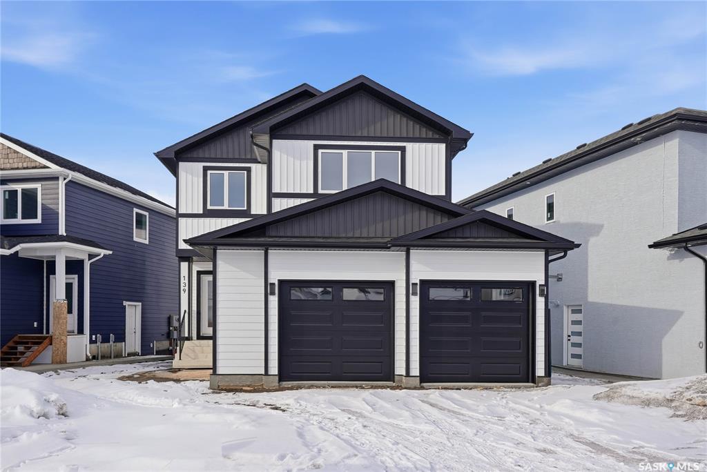 Welcome to refined living in the prestigious community of Aspen Ridge, one of Saskatoon’s most desirable and architecturally stunning neighbourhoods.  This impeccably crafted 1,980 square foot executive two-storey home offers sophisticated design, premium finishes, and exceptional investment potential.  The main level features an elegant open-concept layout anchored by a striking contemporary fireplace and a designer-inspired chef’s kitchen, complete with quartz countertops, upgraded stainless steel appliances, and a built-in beverage fridge — perfect for entertaining.  Upstairs, you’ll find a spacious bonus room, three beautifully appointed bedrooms, and a spa-inspired primary retreat featuring a luxurious five-piece ensuite with dual vanities, a walk-in glass shower, and a deep soaker tub.  The double attached garage, concrete driveway, finished front landscaping, and private side entrance to the lower level elevate both convenience and long-term value.  With the potential for a legal two-bedroom suite and eligibility for the Saskatchewan Secondary Suite Incentive, this home offers incredible income opportunity.  Luxury. Functionality. Investment potential.  This is elevated living in Aspen Ridge.  Book your private tour today. GST/PST included in the purchase price with the rebate to builder.
