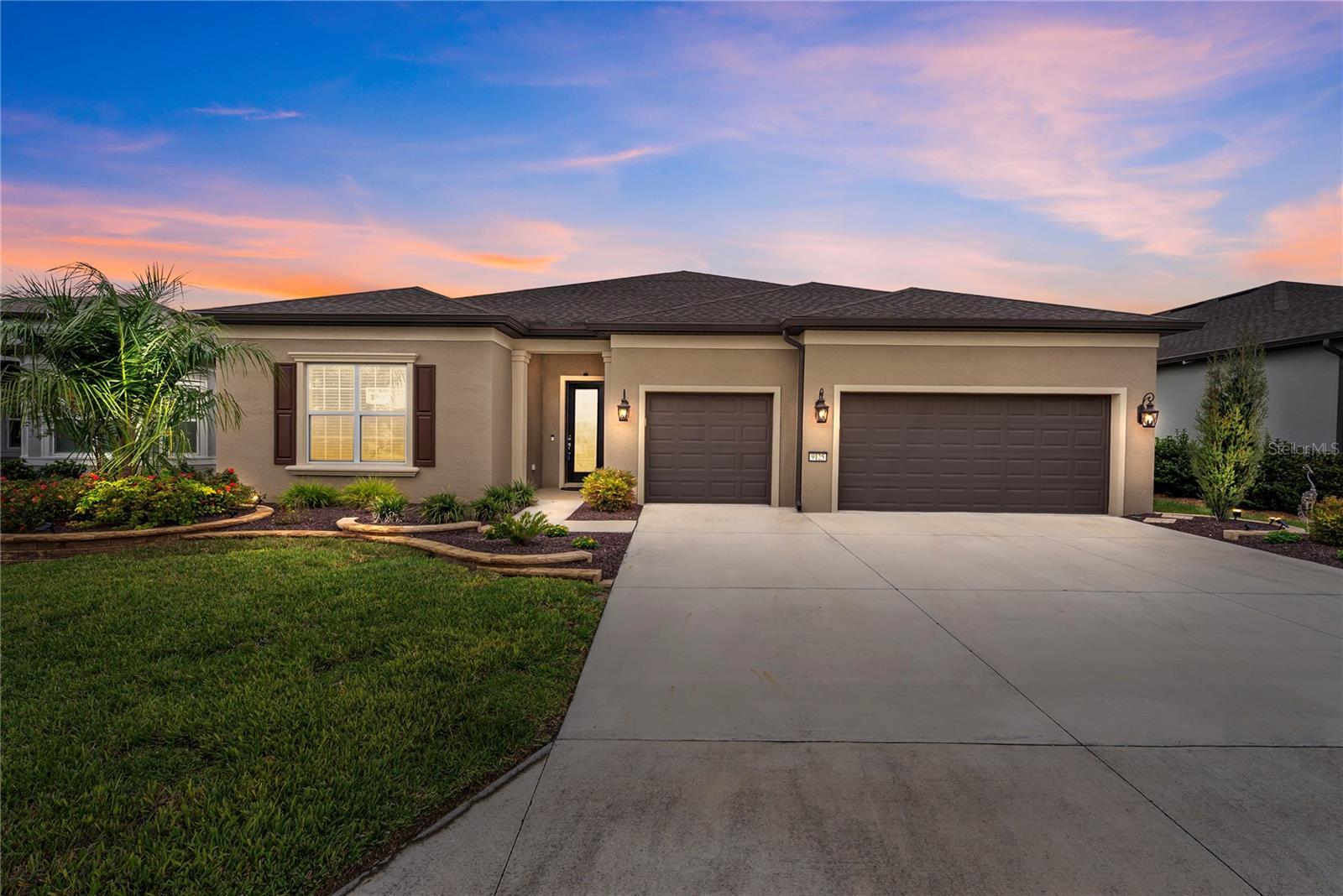 LOWER PRICE! ESCAPE TO YOUR OWN PRIVATE HOME PARADISE! Located in beautiful Del Webb Stone Creek! This Renown 2022 model has everything a luxury home gives. PRIVATE SWIMMING POOL WITH A SPECTACULAR GOLF COURSE VIEW, not to mention the rocky dry retention area beyond the golf course WOW! This spacious home checks all the boxes. Exterior has upgraded coach lights on timers, a premium glass insert on the front door with Wi-Fi keypad lock and professional landscaping. The exterior front home window has custom crown molding and shutters, giving it that special touch. The home opens up into a nice foyer entry, the dining, living room and open floor plan kitchen makes you feel right at home. Wood style ceramic tile in all living areas with luxury vinyl planking in bathrooms, NO CARPET.  A quiet newer dishwasher, composite sink with touchless faucet, soft close cabinet doors, roll out drawers and alluring quartz countertops with auto sensor lighting for the big pantry. Fans in every bedroom and family room. The home features a split floor plan with 2 bedroom guest suites for a total of 3.5 baths. Master bedroom provides two large walk in closets and doorway right into the laundry room, which can also be accessed from the garage open entry. Motion lights have been added in the laundry room, master bedroom and garage, never be in the dark. You will love programmable auto powered Levolor window blinds in the master bedroom, flex room, dining, cafe and family rooms. This home has rounded wall corners with a warm all home paint color. Enjoy the cleanest water with a whole home Eco-water filter and softener in addition to the reverse osmosis kitchen water filter. Walking through the sliding doors into your private pool area with giant birdcage and outdoor kitchen with grill and sink. The 12' x 30' pool is heated by electric and includes pool floor auto cleaner and auto fill technology for low maintenance. In the evening the view is even prettier with pool lighting and fans, all great for entertaining or just relaxing. The three car garage has plenty of room for vehicles, golf cart and storage, if that is not enough, there is already a garage storage rack in place, the garage floor has vinyl tiles and garage door is insulated. Irrigation and home thermostat is controlled with the newest wi-fi electronics that can be operated from your phone. This home has so many upgrades during the building and after. There is nothing for you to do but move in and relish everything that makes life easier. This is a golfers dream home or if you are looking for a private homesite with nothing to look at but green space, with woods and bolder rocks. This community offers many amenities, clubs, activities and has an on property restaurant. Golf carting is fun, go listen to music at the town square and have access to three shopping plaza's with doctors, additional places to eat, go to the dentist and visit three different grocery stores. You can even golf cart to the post office. There are NO homesites like this one! Come and enjoy your best life!