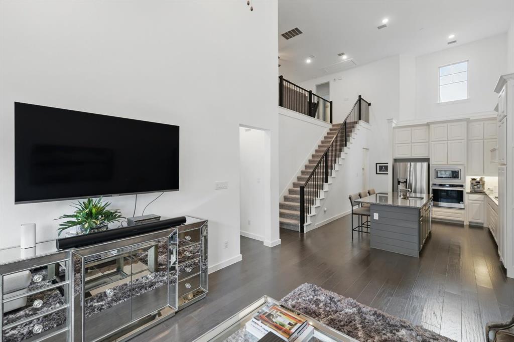 Welcome Home to this exclusive community and this exceptional value! High volume ceilings that soar to the second floor will impress as you step inside. Light and bright with tall ceilings creates spacious feeling.  Primary is on the first floor and is large with designer features and en suite.  Kitchen is open to family room with large island, designer upgrades such as custom cabinets, quartz countertops and stainless built in appliances. Hardwood flooring on the main floor.  A private backyard for outdoor living. Walking distance to shopping, dining, and entertainment.  HOA Fee's include insurance for roof and exterior walls, yard maintenance in front and back, fences and gates, and irrigation system, and there is more.  See docs titled TCTH Maintenance Chart.