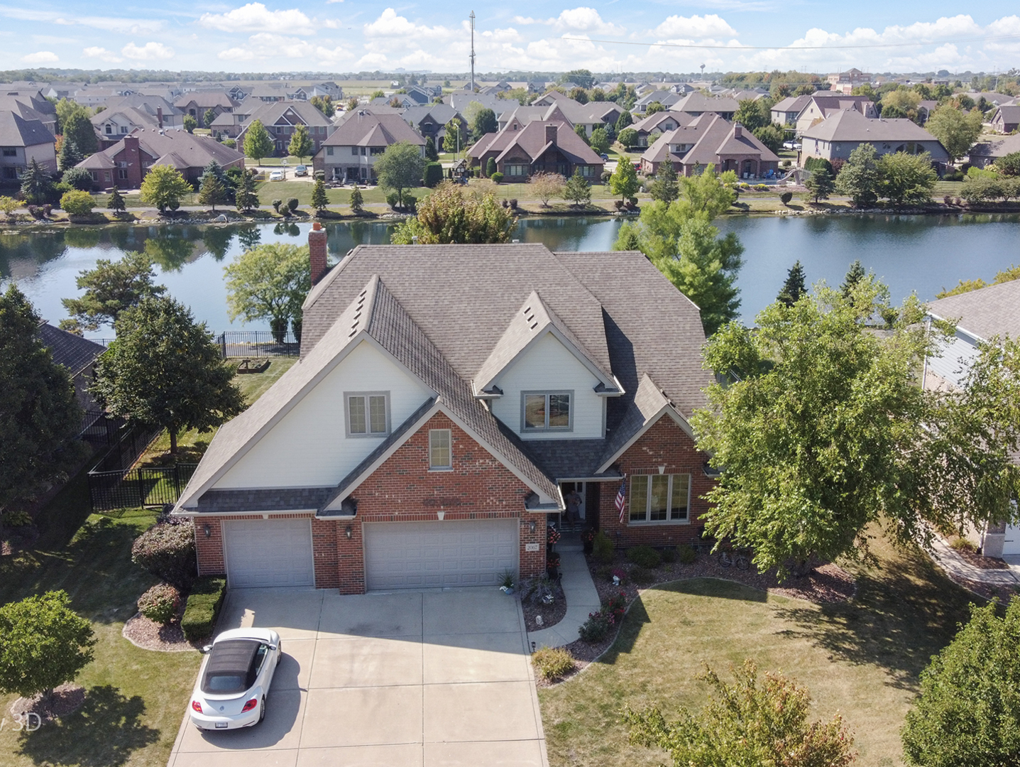 Stunning 6-bedroom home with pond views, entertainer's backyard & top Lincoln-Way Schools - Welcome to this beautiful 6-bedroom, 3.5-bath home with over 4,000 sq. ft. of living space designed for both everyday comfort and exceptional entertaining. Nestled in a highly sought-after neighborhood, this home offers breathtaking pond views and a fully finished basement.  Step inside to find freshly refinished oak hardwood floors, new carpeting on the stairs, and an inviting layout. The spacious kitchen is a chef's dream, featuring skyline cherry cabinetry, granite counters, stainless steel appliances, pantry, and a 6-foot island with seating-all with plenty of room for a large kitchen table. The family room has a cozy fireplace while offering backyard views, perfect for gathering with family and friends. Upstairs, the primary suite is a true retreat with stunning pond views, a walk-in closet, and a spa-like bath complete with jacuzzi tub, dual vanities, walk-in shower, and private water closet. The second full bath also features double vanities and a shower/tub combo for added convenience. The finished basement is an entertainer's paradise-complete with a kitchenette (refrigerator, range, sink), dry bar, second fireplace, full bath, and the 6th bedroom, plus ample storage. Step outside to your private backyard oasis, where a brick paver patio, pergola, natural gas grill, and firepit await-perfect for year-round entertaining in a fully fenced yard with tranquil pond views. Car enthusiasts will appreciate the 3-car garage, including one custom bay with its own heat and A/C. All this in a vibrant neighborhood with a newer park featuring pickleball, basketball, shuffle board court, bags court, walking paths, and more-all served by highly acclaimed Lincoln-Way schools. This home truly has it all-space, style, views, and a location that can't be beat.