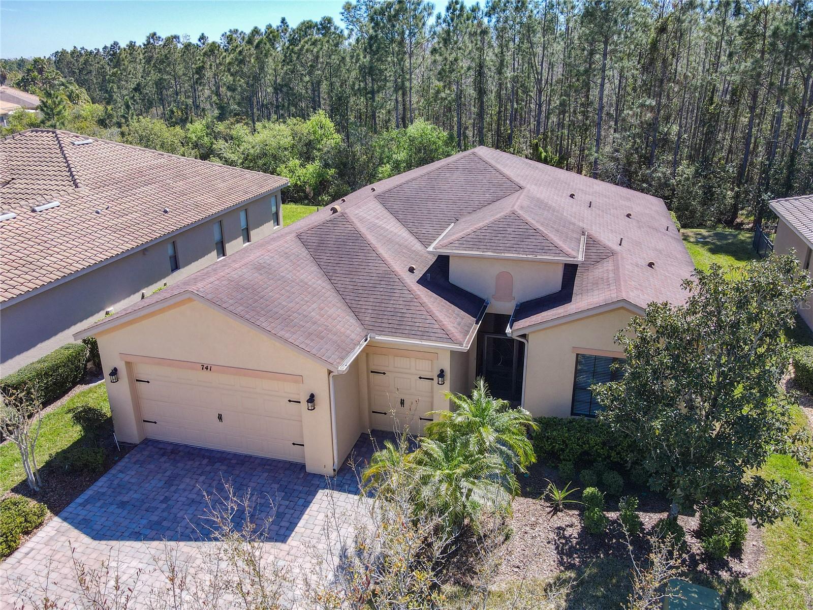 Fantastic Cannes Model on a conservation lot.  Starting at the upgraded stunning lead crystal entry door, you walk into the kitchen that includes 42" pecan cabinets, granite countertops, backsplash, undercounter and over cabinet lighting and a wine glass rack with a separate breakfast nook.  Off the kitchen is the laundry area with newer Maytag Washer and Dryer and matching cabinets.  This home includes diagonal ceramic tile flooring throughout.  All window treatments including the Hunter Douglas blinds in the kitchen and the dining room, upgraded fans throughout, 2 master suites.  Master suite 1 has custom cabinets installed in the walk-in closet.  Master suite 2 has a walk-in closet, a 3rd bedroom with an adjacent full bath, and a large floor mounted Liberty safe in the 2nd master bedroom.  The bathrooms include upgraded tile with lístelos and designer sinks.  Custom Crown Molding in all public areas of the home.  Double pane low E insulated glass in all windows.  All toilets are senior height, elongated high efficiency.  The large 32 x 14 screened lanai includes 2 concrete slabs outside of screened area for your grill or a seating area, a 3" insulated roof, 3 outdoor fans and Podocarpus hedges on both the East and West sides for privacy.  Air Conditioner was replaced in 2019 with a 15V seer dehumidification system series 3-ton heat pump and a new compressor was installed in 2024.