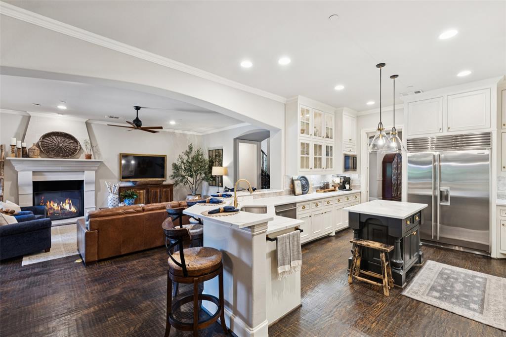 This exquisite home in the highly sought after Twin Creeks community captures the perfect blend of sophistication and comfort. From the moment you enter, you are welcomed by fresh designer paint, elegant new lighting, and a floor plan that combines open concept living with thoughtfully designed spaces. At the heart of the home is the chef’s dream kitchen featuring a Wolf and SubZero appliance suite with double ovens, a 6 burner gas range, built in refrigerator, and stunning finishes. The kitchen opens seamlessly to the family room and breakfast nook, making it an ideal space for gathering and entertaining. Formal dining and an additional living room provide even more versatility for hosting and everyday living. The layout boasts 5 spacious bedrooms plus a dedicated office, with 2 bedrooms conveniently located downstairs including the serene primary suite. The primary retreat is both elegant and functional with a spa like bathroom and an expansive walk in closet that feels more like a private boutique. Upstairs you’ll find 3 additional bedrooms, 2 full baths, a large game room, and a media room perfect for movie nights or game day. Downstairs also offers 2 full baths and 2 half baths for ultimate convenience. The 3 car garage is finished with sleek epoxy flooring adding style and durability. Step outside to your own private paradise. A covered patio invites relaxation and outdoor dining, while the newly resurfaced pool and spa shimmer as the centerpiece of the backyard. Two large grassy yards provide ample play space, and a secure gated area offers additional parking inside the property. Living here means enjoying all that Allen has to offer, including top rated schools and recreational centers such as the one just down the street. Twin Creeks itself is unmatched with golf, tennis, trails, pools, and community events that create a true resort style experience. Impeccably cared for and luxuriously updated, this home is a perfect balance of elegance, function, and fun.