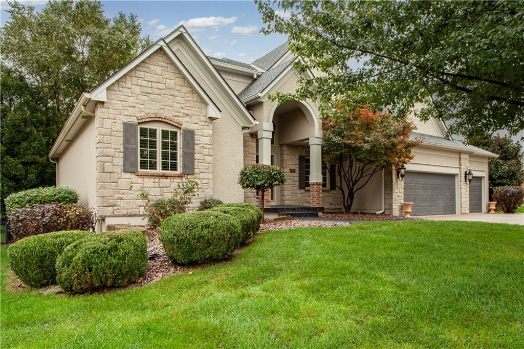 This 5 bedroom, 4 1/2 bath 3 car garage home is move in ready with many bells and whistles including a main level primary bedroom and bath making this spacious home great for the empty nester and growing families alike. You'll love the hard surface flooring on the main level starting with the two story open feeling great room that opens up to the spacious kitchen and hearth room spaces. Relax in the vaulted hearth room by the fireplace while dinner is being prepared and after dinner hang out on the covered back composite finished deck area sipping on a nice cool drink and winding down, or fire up the included grill plumbed with natural gas. Off the kitchen area is a main level laundry right next to a convenient separated built in desk space to store your mail or help the kids with some after school homework. You'll love the main level primary bedroom and bathroom. The bedroom overlooks the treed backyard and has a second fireplace, the primary bath has a tiled walk in shower, separate vanities, relaxing garden jetted tub outlined with elegant pillars, and a very large walk in closet complete with built in drawers. The expansive upper level has three nice sized bedrooms, all with walk in closets and a bonus loft for gaming or an upstairs open office area. As you walk down the fancy curved staircase to the finished lower level, you'll notice with all of the daylight windows how you feel like you are in nice bright and open family space. With the wet bar/kitchenette area complete with fridge, dishwasher and microwave, you have almost all the features of a second kitchen. The lower level full bath is convenient to the 5th bedroom and family room areas. The exercise/media room also has bright daylight windows and another space in the lower level could make a cool game room or kids play space to keep your family room clean and neat. The metal fenced backyard has a huge concrete patio and is also nicely landscaped consistent with the entire yard, front and side yards.