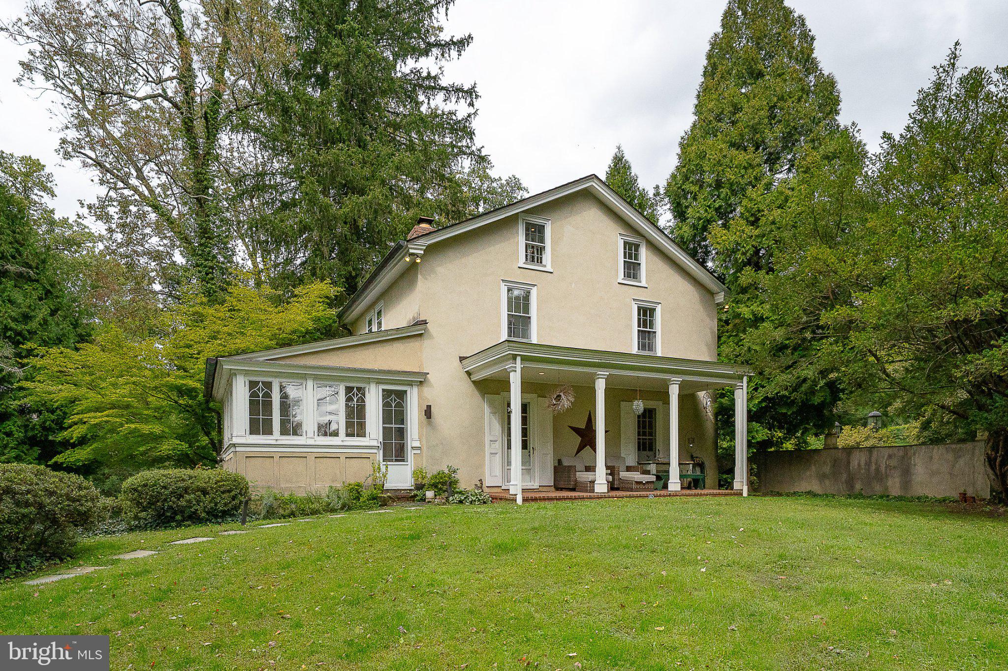 Set on a beautifully manageable acre in the estate section, this distinctive residence offers an unusual combination of architectural presence, privacy and ease. Extraordinary detailing is evident throughout, but it is perhaps the windows that are most memorable: beautifully scaled and exquisitely detailed, they frame private views of the surrounding landscape while giving each room its own architectural character.  Inside, the home is sophisticated and highly styled, with two marble fireplaces anchoring the principal living spaces. A beautifully updated kitchen balances clean, current design with the character of the architecture, while the renovated baths are equally refined in their materials and execution. A loft office adds an unexpected and appealing workspace, removed from the primary living areas yet visually connected to the home.  With only 2 bedrooms, the residence is particularly compelling for those who want to maintain a substantial Main Line presence without the burden of rooms that are rarely used. The scale is generous where it matters, yet refreshingly right sized for everyday living.  Outside, approximately one acre provides privacy and a lovely sense of setting without the maintenance demands of a larger estate. The result is a rare offering: an architecturally significant home in an established estate setting, beautifully updated and exceptionally suited to a buyer seeking sophistication, privacy and a more effortless way to live on the Main Line.