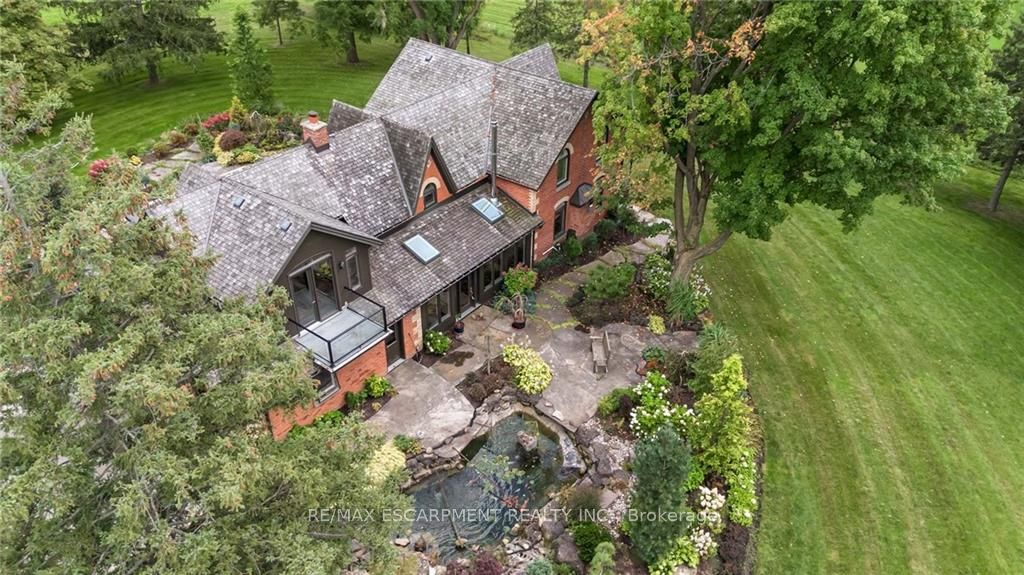 This unique property is located on 51+ acres of stunning farmland w/ 2 large barns & a picturesque pond w/ serene waterfall & dock. The perfect mixture of rustic & modern flare, this home boasts 3000+ sqft of living space & has been renovated from top to bottom. Enter the main doors to your light filled sanctuary. The custom kitchen is a chefs dream complete with Jenn-Air wall ovens, integrated Kitchen Aid double fridge & Thermador 6 burner double wide range. There are 5 bedrooms including a private primary retreat with balcony overlooking the grounds. The ensuite features a soaker tub, steam shower, heated floors & vanity. Entertain guests with comfort & ease in the second primary suite, complete with ensuite & WIC. Outdoors you will find 2 large barns, one complete w/ garage door, man door, wood fireplace & concrete floors. The 2nd features high ceilings, large window & sliding door. This home is packed with so many updates & upgrades it truly needs to be seen to be appreciated. RSA.