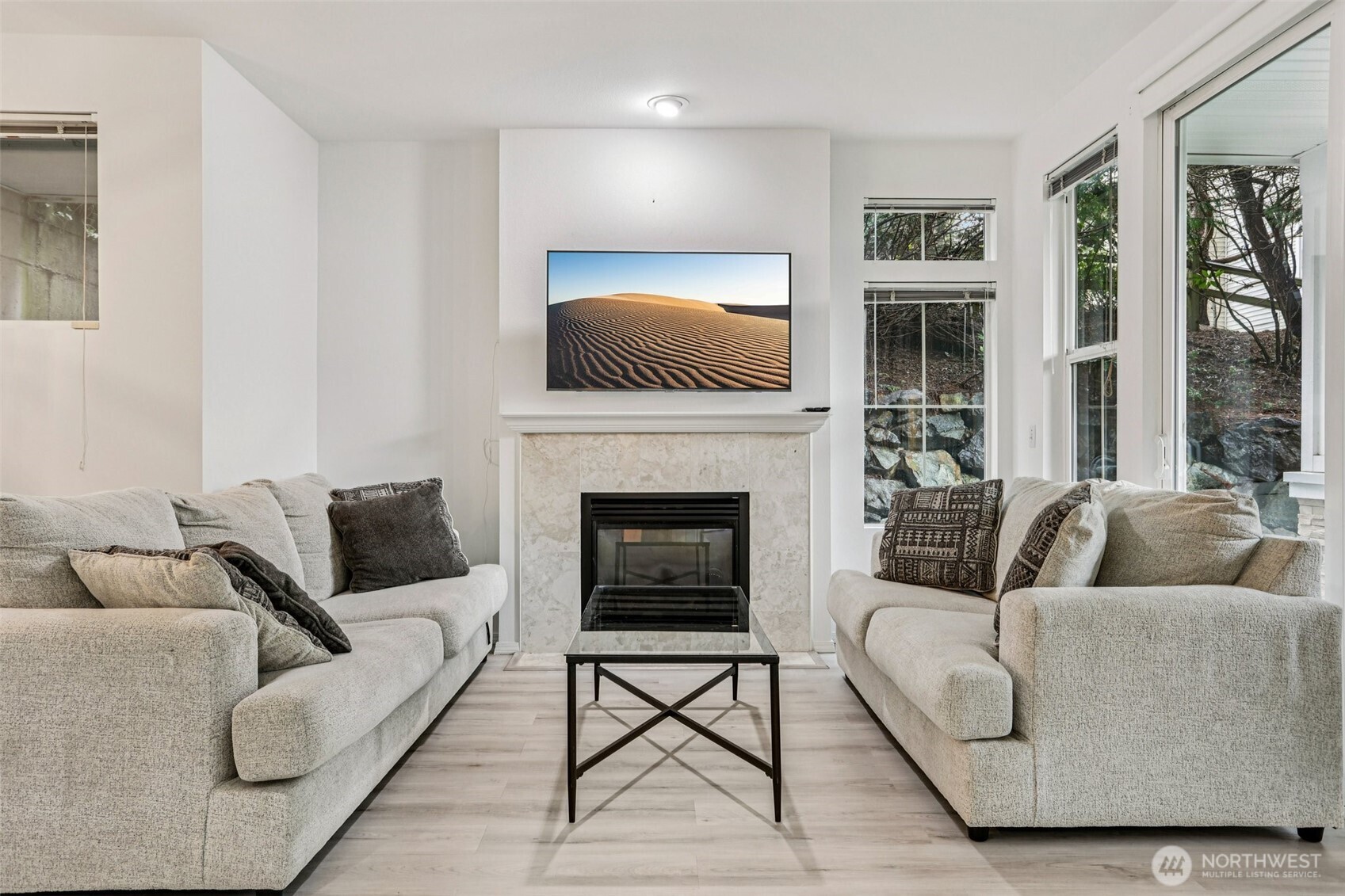 This beautifully updated ground-floor corner condo in Summerhill Village offers the perfect blend of modern luxury & effortless, no-stairs living. The entire home has been thoughtfully renovated, featuring brand-new LVP flooring that flows seamlessly through an open-concept layout accented by soaring 9 ft ceilings & a cozy gas fireplace. The heart of the home is a stunningly remodeled kitchen, complete with sleek quartz countertops, contemporary cabinetry, & high-end SS appliances. Both full bathrooms have been tastefully modernized to match the home's fresh, sophisticated aesthetic. The functional floor plan provides 2 spacious bedrooms & 2 full bathrooms, ensuring comfort & privacy for residents & guests alike. Outside, a private patio nestled among mature landscaping creates a serene retreat, while the detached private garage offers rare, secure parking & extra storage space. Plenty of visitor parking for your guests. Recent upgrades, including a newer water heater, provide additional peace of mind for years to come. Perfectly positioned within the prestigious Issaquah School District & just minutes from the new Cedar Trails Elementary, this location provides unparalleled access to major freeways, premier shopping, & local entertainment. With low HOA dues, strong reserves, & no rental cap, this turnkey property is an exceptional find for homeowners & investors.