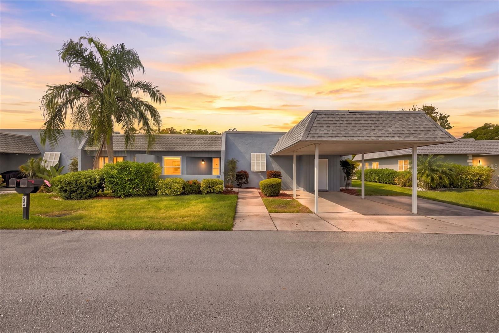 Enjoy golf course views and comfortable Florida living in this 2-bedroom, 2-bath condominium in Seven Springs Villas. The spacious layout features 1,608 square feet of living space, an open living and dining area, and large sliding glass doors that bring in natural light and showcase the surrounding green space. The kitchen features a breakfast bar, ample cabinet storage, and a convenient connection to the main living areas. The primary suite includes a walk-in closet, while the guest bedroom and second full bathroom provide comfortable accommodations for visitors. Additional features include a wood-burning fireplace and inside laundry. Step out to the screened patio and enjoy peaceful golf course views. Recent updates include fresh interior paint, a new screen patio, water heater, water softener, exterior lighting, and upgraded closet shelving. Additional improvements include updated fans and lighting, kitchen appliances, and door hardware. A covered carport provides convenient parking, and community amenities include a pool, clubhouse, tennis courts, and recreational facilities. The monthly condo fee includes water, sewer, trash, cable TV, internet, grounds maintenance, and recreational facilities. Conveniently located in the Seven Springs Golf & Country Club community, this property is a great opportunity to enjoy a relaxed Florida lifestyle. Schedule your showing today!