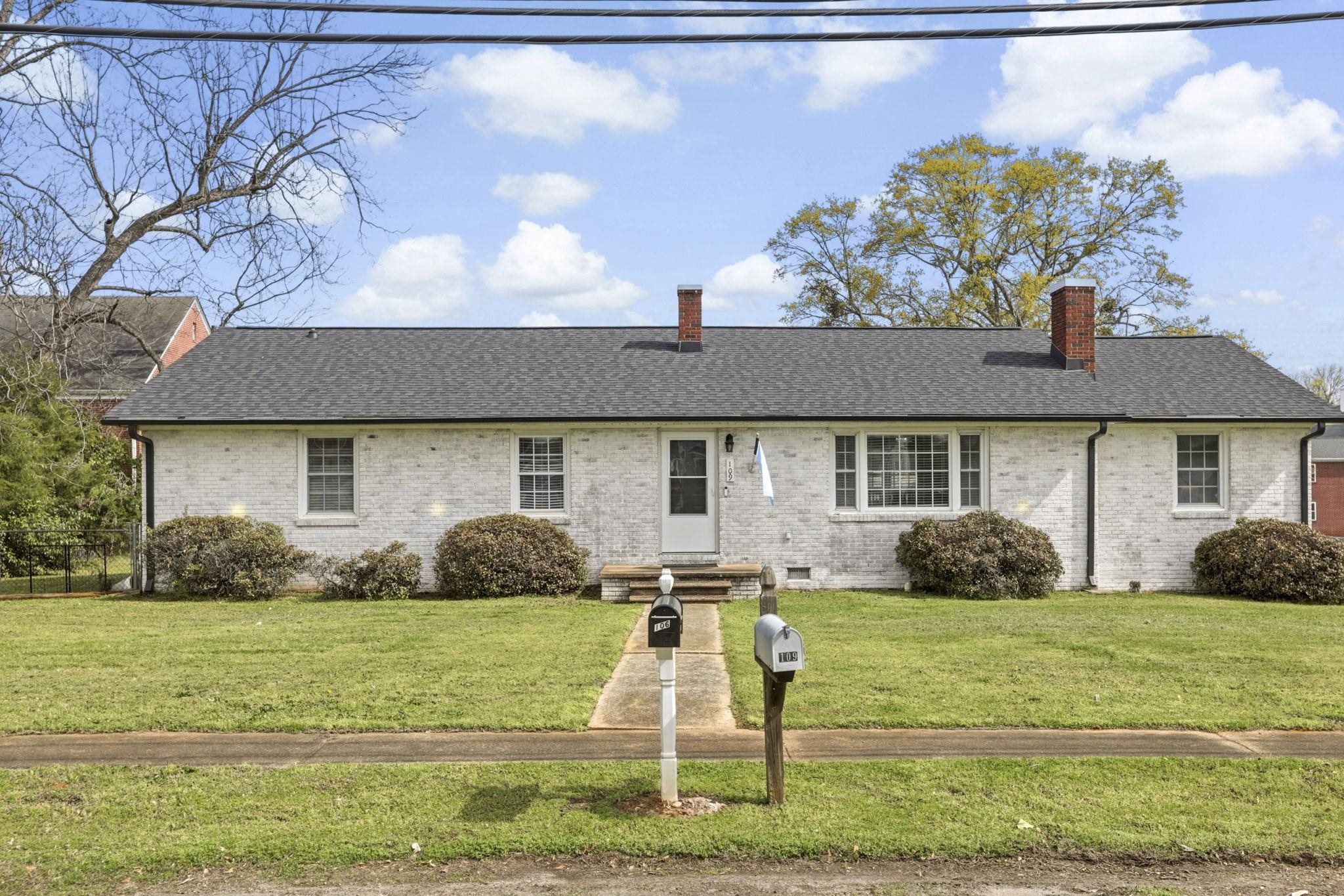 Charming Limewashed Brick Home in the Heart of Cowpens!  Beautifully renovated 3-bedroom, 2-bath all-brick home offering 1,649 sq ft of living space, perfectly situated on a spacious 0.44-acre lot with NO HOA. This limewashed exterior adds timeless character and curb appeal, while the interior blends classic charm with modern updates.  Step inside to find original hardwood floors throughout, a large kitchen with ample space for cooking and entertaining, and a generous dining area. The inviting living room features a cozy fireplace, creating the perfect gathering space.  Outside, enjoy a large fenced backyard, attached carport, and additional parking pads for added convenience.  Located in the quaint town of Cowpens, this home is within walking distance to local shopping and dining, and just a short 10-minute drive to downtown Spartanburg.  Move-in ready and full of charm—schedule your showing today!