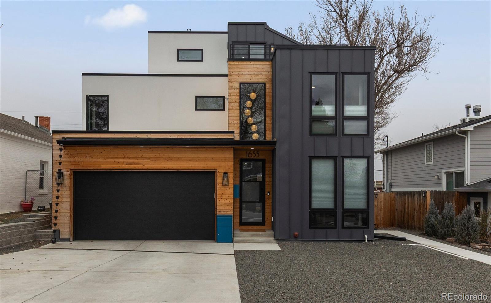 There aren’t many homes that can claim mountain and lake views, a park-like setting, and a location right across the street from beloved Sloan’s Lake. There are even fewer that can also boast an upscale, contemporary-modern design, two rooftop decks, and a gorgeous, rental-ready basement suite with a full kitchen, living room, bedroom, bath and a separate entrance. The entire interior shines with luxe finishes: designer lighting, flooring, premium carpets, tall baseboards, up-down blinds, chic metal stair railings and high-end treatments. The main level steals the show with the kitchen as the star thanks to a large island topped with polished quartz, two dishwashers, a Sub-Zero fridge, Wolf gas range with a pot-filler faucet, and a walk-in pantry with a coffee bar. Comfy gathering and getaway spaces abound, from the sunlit living room with a gas fireplace and the spacious dining area to the separate study with an adjacent powder room. A beautifully finished mudroom area connects to your oversized garage with finished floors and storage. Up one level is your expansive primary suite with Sloan’s Lake views and a spa-like bathroom, plus two large additional bedrooms, a guest bath with stunning tilework and a laundry room with 2 sets of washers and dryers. On the third floor is a truly unique space: a hideaway perch with two rooftop decks to admire sunsets over the lake, city lights and mountain panoramas. With a wet bar, full bath and huge windows, this could be your media room, art or yoga studio, living quarters or whatever captures your imagination. Back on the ground, you’ll have a large yard to play or lounge in, with worry-free turf, and patios for alfresco moments. Enjoy the peace of mind of a backup generator, plus dual-zone furnace and tankless hot water.  When you’re not relaxing at home, enjoy the nearby restaurants, bars, basketball and tennis courts, playgrounds and the water recreation just across the street or zip into downtown Denver for urban fun.