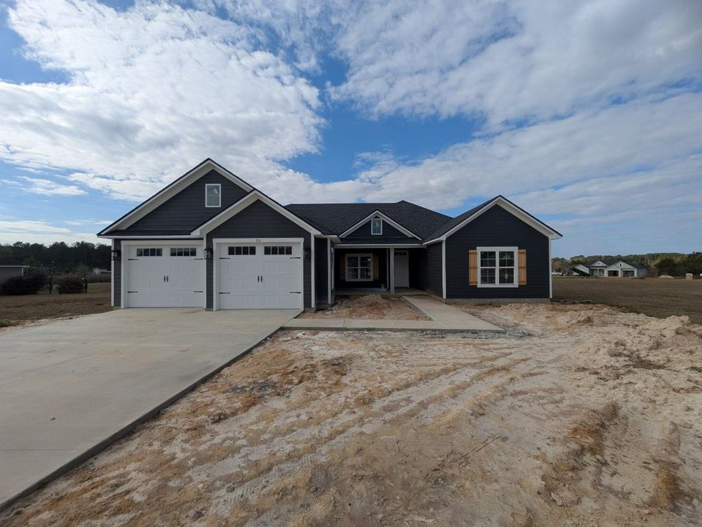 Brand new 4 bed/2 bath home located in the spectacular Southern Pointe subdivision! Ideally located, this home offers all the comforts of being close to town while still providing the space and privacy of the countryside. The front and back porches are the perfect areas to sit back, relax, and enjoy the breeze. This spacious .96 acre lot offers plenty of space for both kids and pets to run around and play. Inside the house, the soon to be impeccable kitchen is great for making meals while your kids or guests sit at the island countertop or in the living room. The trey ceiling in the living room and master bedroom gives the spaces a large and open feeling. You'll never feel claustrophobic here! The master bedroom comes with a gorgeous master bathroom that offers beautiful double vanities, a luxury shower, and a gigantic walk in closet. On the other side of the house, there are three more bedrooms which are perfect spaces for kids, an office, or for extended family when they come for a visit!