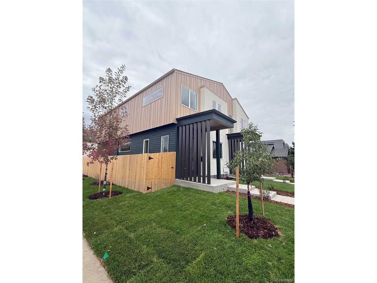 This modern new construction home on a corner lot on a great South Englewood block pairs thoughtful design with a layout made for everyday living and entertaining. Large windows fill the main living spaces with natural light, while carefully selected finishes and modern architectural details carry throughout. Just inside the entry, a built-in bench creates a convenient drop-off zone for bags, shoes and everyday essentials.At the heart of the home, the spacious kitchen features two-toned cabinetry with warm walnut tones paired with dove slim Shaker cabinets, a large island, open shelving, quartz countertops, vertically stacked tile backsplash and matte black fixtures and lighting. The Samsung appliance package includes a refrigerator with a Beverage Center built into the door and a sleek microwave drawer. The open layout flows seamlessly into the living and dining areas, creating a beautiful, highly functional space designed for gathering.Upstairs, dramatic gabled ceilings span the upper level, adding architectural interest, volume and an unexpected sense of luxury. TWO PRIMARY SUITES each offer a walk-in closet and private ensuite bath. One features a spa-inspired wet room with the soaking tub integrated within the shower and sleek slim Shaker cabinetry. The second ensuite carries the warm walnut cabinetry upstairs and features a double vanity. A wide hallway connects the two suites, with conveniently located laundry hookups nearby.A dedicated office provides flexible space for working from home, a studio or reading room, while a powder bath serves the main level. Outside, the fenced backyard and grounds are immaculately landscaped with a low-maintenance design, and the detached two-car garage provides additional parking and storage.Set on a great block in Englewood, the home is convenient to the Englewood light rail station, CityCenter Englewood and the shops, restaurants and entertainment along South Broadway, with easy access to Hampden and Santa Fe.