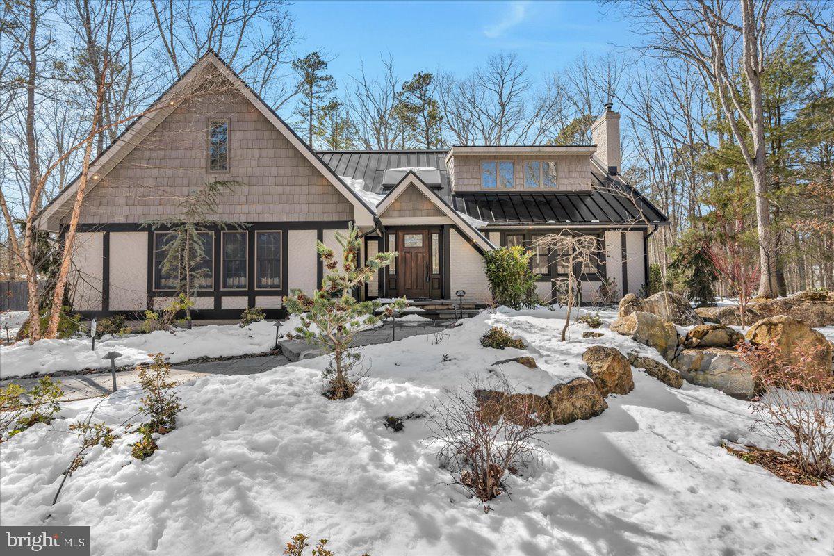3/4 bedroom, 2.5 bath English-styled cottage nestled on over 3+ acres of wooded privacy in Medford Township! With its cedar shake siding and brick accents, this is truly a one-of-a-kind home. Pull up to the circular driveway and enter through the sun-filled two-story foyer, featuring hardwood floors throughout, with heated floors in the sunroom and primary bath. Enjoy peace of mind with a new metal roof (2018) and a stunning David Ramsay kitchen complete with commercial-grade appliances, a farmhouse sink, custom-made snack bar, and a soapstone island. You’ll love the abundance of Andersen windows, allowing natural light to pour in. The living room offers a beautiful brick fireplace, plus a family room with charming beam ceilings. Upstairs, you’ll find three spacious bedrooms and a former fourth bedroom that has been transformed into a custom dressing room/closet. The luxury primary suite feels like a Vail, Colorado retreat, featuring a spa-like bath and vaulted beam ceilings. That’s not all, the oversized garage, currently used as a music studio, offers incredible flexibility and can easily be converted back to a garage with the door intact. The garage connects to a full basement, providing fantastic space for storage, a wine cellar, or whatever suits your needs. Additional features include a custom fence surrounding the property, generator, gazebo with hot tub, tankless hot water system, new HVAC (2016), and over $100,000 in landscaping.  This home is a happy space giving nature a run for the money!