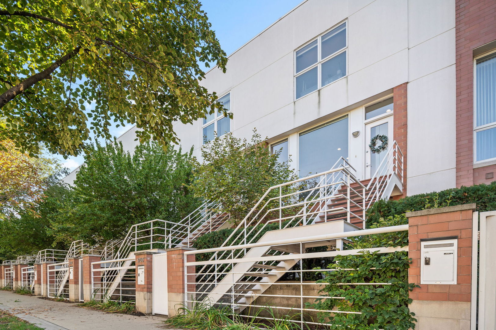 Nestled in the heart of Wellington Park within the highly sought-after Burley Elementary School District, this beautifully updated 4-bedroom, 3-bath townhome offers exceptional space, light, and versatility. With an attached 2-car garage plus a 2-car parking pad and 4 private outdoor spaces this home combines convenience with comfort in Chicago's desirable West Lakeview neighborhood. Enjoy abundant natural light from north and south exposures with full height windows. High ceilings and an open plan create an ideal second floor for entertaining. The inviting living area includes a gas fireplace and a balcony off the kitchen is perfect for grilling or relaxing. The kitchen is well appointed with a large island, generous counter space, built-in cabinetry, double ovens, and a pantry. The spacious primary bedroom with ensuite bath is located on the third floor along with a second bedroom and a full bath. The fourth floor bedroom has 2 roof decks finished with Trex along with 2 new Pella sliding doors and a new roof in 2024. The first floor has a bedroom with built-in murphy bed, laundry and a ground level patio adjacent to the third full bath and garage. Ideally situated between Southport Corridor and Roscoe Village, residents enjoy easy access to popular boutiques, restaurants and conveniences such as Target and Whole Foods. Chi Che Wang and Hamlin Parks are just steps away, and the Paulina Brown Line station is less than a mile for effortless commuting downtown.