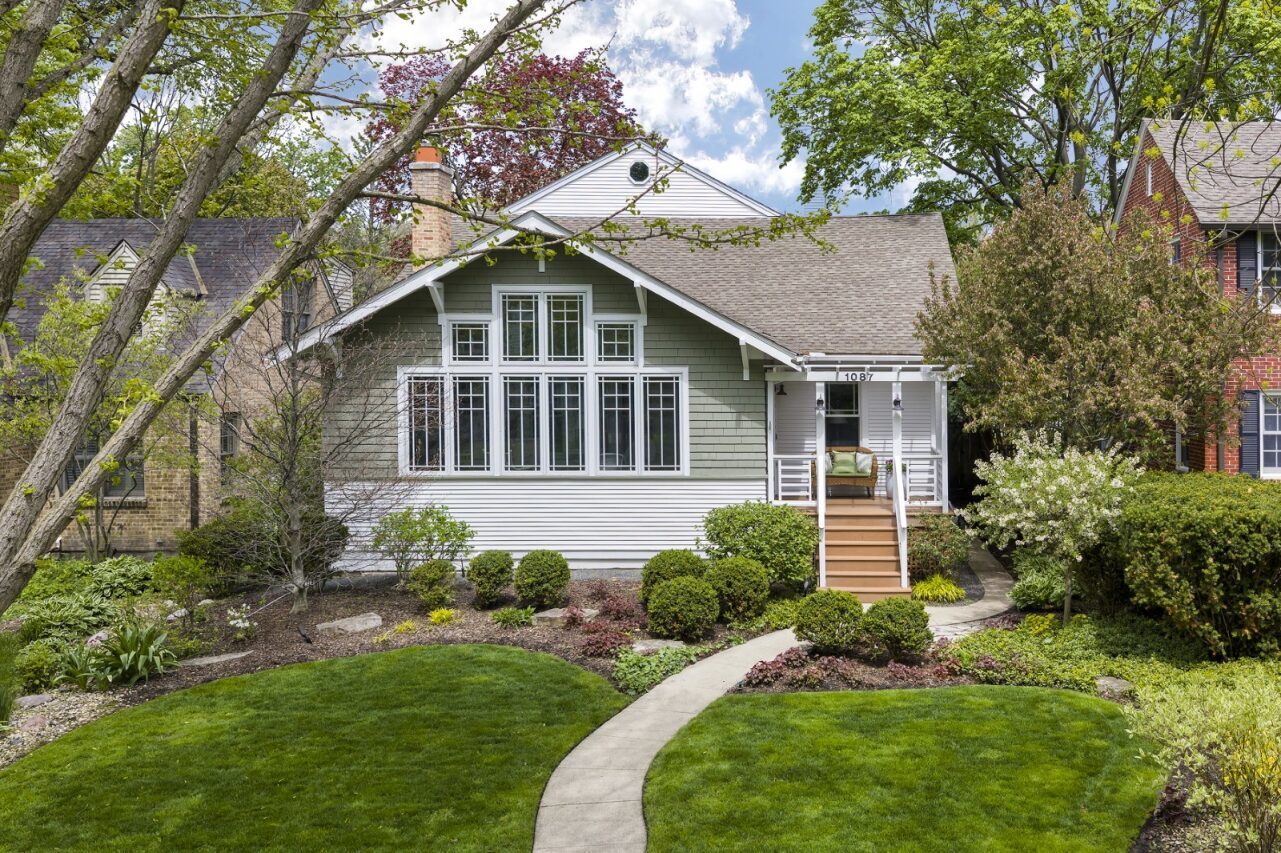 If you are looking for a right-size, upsize, or downsize home that can effortlessly adapt to your changing needs, you've found your dream home. 1087 Ash is pure perfection! There is so much more than meets the eye, as the substantial addition is beautifully tucked behind the original home. Step into the sunny three-season room - perfect for morning coffee or an afternoon mahj game - and sets the reveal of the incredible space and light this home offers. The formal living room, with leaded glass windows and a wood-burning fireplace, flows into an entertainment-sized dining room and then into the thoughtfully updated kitchen, featuring chef's appliances, a large island, and banquet seating for six. An adjoining sun-filled family room with custom built-ins and a gas fireplace opens to the deck overlooking the lushly landscaped backyard. And wait for it- the big surprises on the first floor: a 4th bedroom with an adjacent full bath plus two additional bonus rooms that can flex to fit your lifestyle. Need a 5th bedroom and an office? Check. Two offices and a playroom? Check. An office, gym, or guest space? Check. These extra rooms are a true luxury! Head upstairs and you'll find two generously sized family bedrooms with great closets, a pretty hall bath, and a super spacious primary suite with vaulted ceilings, two walk-in closets, and a beautifully updated bath. The lower level adds even more versatility with a carpeted rec room, bonus room, storage space, and a large laundry/mechanical/storage area. The outside space is equally fab-the professionally landscaped yard is lovely, and there is a 2 car garage with a parking pad for 2 cars on the alley.  And can we talk about the fabulous tree street location? It's a dream! No need to carpool to school- Grades K-8 Winnetka schools are just blocks away.  Walk or bike Winnetka Park District golf, tennis, paddle, ice rink and ballfields, the Metra, and all of the fabulous restaurants ( Pomeroy, Tocco, Hometown and more!) and shopping  in vibrant downtown Winnetka.  What more could you want? 1087 Ash checks every box - and then some! Don't miss this incredible home- it is truly special!