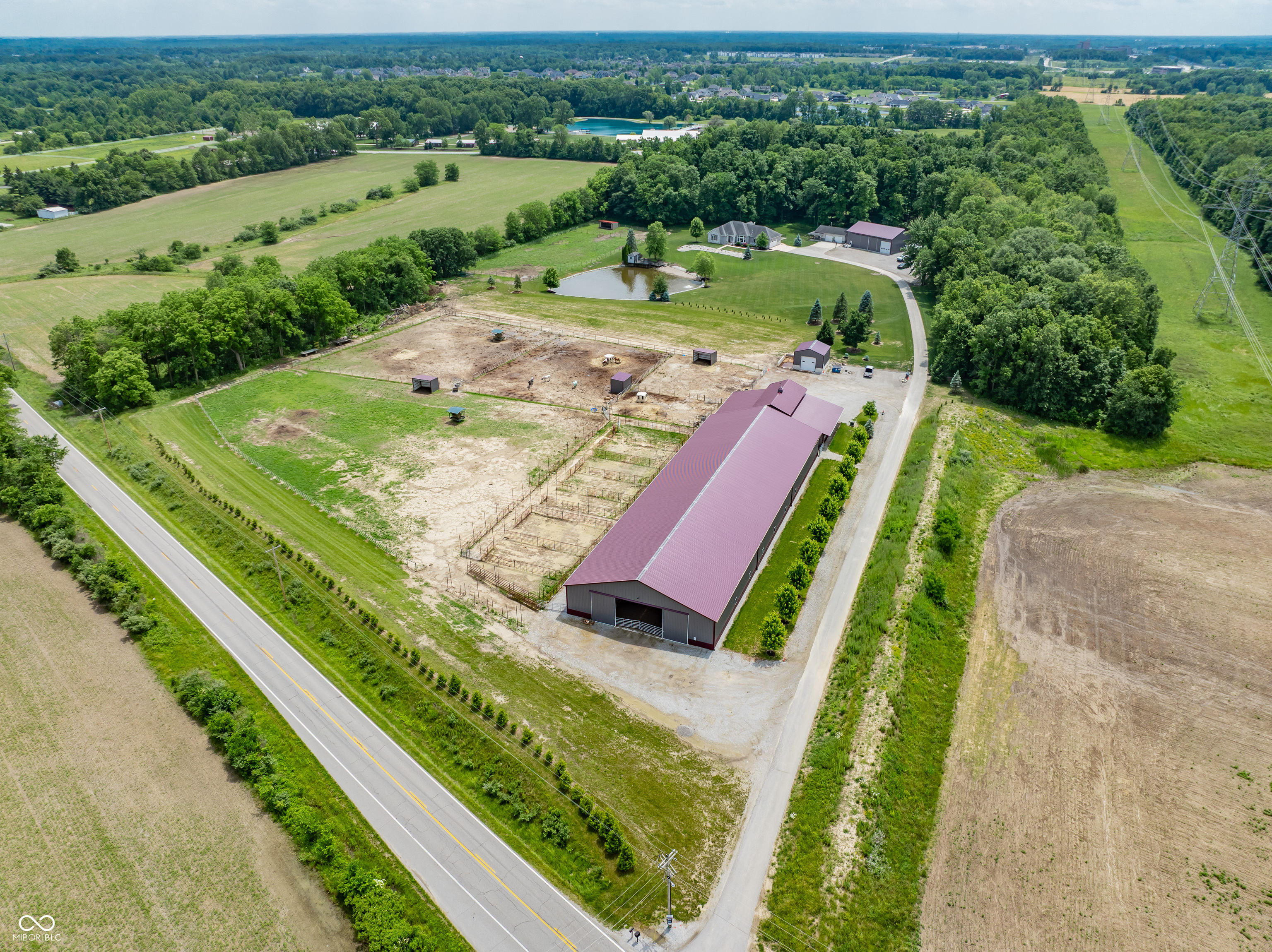 AUCTION: Auction held onsite, Saturday, August 2, 2025, 10:00 AM Eastern | Open House Monday, July 14, 2025 & Monday, July 28, 2025, 5:00 - 6:30 PM Eastern| The price stated on this property is the guideline price. | This property may sell for more or less than the assessed value, depending on the outcome of the auction bidding. | $80,000 down day of the auction. | To see all terms, please visit our website.  Incredible opportunity to own a beautiful slice of Americana including amazing custom ranch on full finished basement, pond, outbuildings, woods & 17.3 spectacular acres-in NWAC school district! (Note: Property will be sold in 3 Tracts-Tract 1) Home & Buildings; Tract 2) Horse Riding Stable; Tract 3) Combination of 1 & 2.) Located in ultra quiet & peaceful area not far from I-69, long private gated driveway links to stunning 2010 built 4 bedrooms, 3.5 bath home is sure to wow from moment you arrive. Attractive exterior is mixed materials w/detailed landscaping, attached 2.5 car garage (w/18x8 door, power washer, vacuum, mounted hose & walk-up staircase to storage room) & impressive front entrance. Inside you'll find a warm & welcoming atmosphere complemented by the wood floors, earth tone color palette & tons of natural light. Majestic great room has tray ceiling, stone fireplace & giant wall of windows. Head on back to the gourmet eat-in kitchen w/ granite counters, custom cabinets, ceramic backsplash, SS appliances, dbl oven, custom cooktop w/ pot filler & large central island w/seating. Generous primary bedroom has vaulted ceiling w/ pond view & en suite bath w/ dual sink vanity, walk-in ceramic shower & walk-in closet w/ upper-level racks. 2 more comfortably sized bedrooms w/ ample storage throughout; den w/ glass French doors (possible 4th bedroom). Laundry room w/ utility sink & lockers; half bath; & full shared bath complete main level. Daylight basement boasts full wet bar, full bath & big entertainment area audio wired. Other features include closet