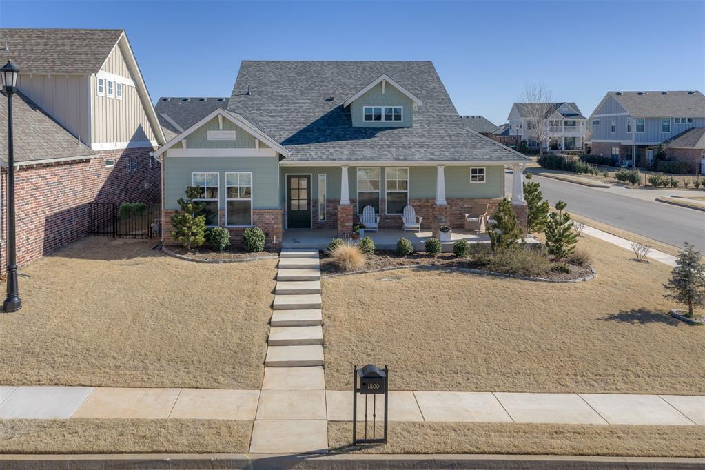 Welcome home to this stunning 2023-built residence perfectly positioned on a desirable corner lot, offering 1,611 square feet of thoughtfully designed living space with 3 bedrooms and 2 bathrooms. From the moment you arrive, the inviting front porch sets the tone—an ideal spot to relax and take in peaceful neighborhood and sunset views. Inside, hardwood floors flow throughout the home, enhancing the open-concept layout that seamlessly connects the living room and kitchen. The heart of the home is the spacious kitchen, featuring a large center island, a premium Wolf gas range, custom window treatments, and modern finishes that make both everyday living and entertaining effortless. A complete smart-home system adds convenience and efficiency, while the insulated garage door provides year-round comfort. Step outside to a backyard designed for enjoyment and relaxation. The sellers have extended the patio with composite decking tile and created a show-stopping rock wall complete with a built-in gas fireplace—perfect for cozy evenings or entertaining guests. Thoughtfully updated landscaping and the addition of 17 trees provide beauty, shade, and privacy. This zero-lot-line home offers truly low-maintenance living, with the HOA maintaining the lawn so you can spend more time enjoying everything this community has to offer. Neighborhood amenities include a beautifully appointed clubhouse, top-notch fitness center, resort-style pool, arcade room for kids, basketball court, community garden, scenic walking trails, and a tranquil pond with a fishing dock. With high-end upgrades, exceptional outdoor living, and resort-style amenities, this home delivers comfort, convenience, and an elevated lifestyle—all in one  package. Ideally located with easy access to the interstate, shopping, restaurants, and everyday conveniences.