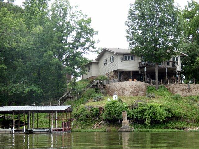 . Imagine waking up to the gentle sounds of the water, sipping your morning coffee on the expansive deck while the mist rises off the lake. Located in a peaceful, quiet neighborhood just minutes from the vibrant energy of Branson, this beautiful 4-bedroom, 3-bathroom waterfront home offers over 2,400 square feet of inviting, sun-drenched living space perfect for making lasting memories.Whether you are hosting a lively summer BBQ on the patio or wrapping up the perfect day roasting s'mores around the crackling fire pit, this property is designed for seamless indoor-outdoor living.For the water enthusiast, your private playground awaits directly below the house. Walk down to your own shore to find two private boat slips equipped with lifts, ready for your next lake adventure. Here, the day's toughest decision is simply choosing between world-class trout fishing or tapping into the area's best-kept secret: trophy big bass fishing.With two spacious garages and a large utility shed, you will have all the room you need to store your boats, jet skis, and lake toys. This isn't just a home--it is a lifestyle waiting to be lived.