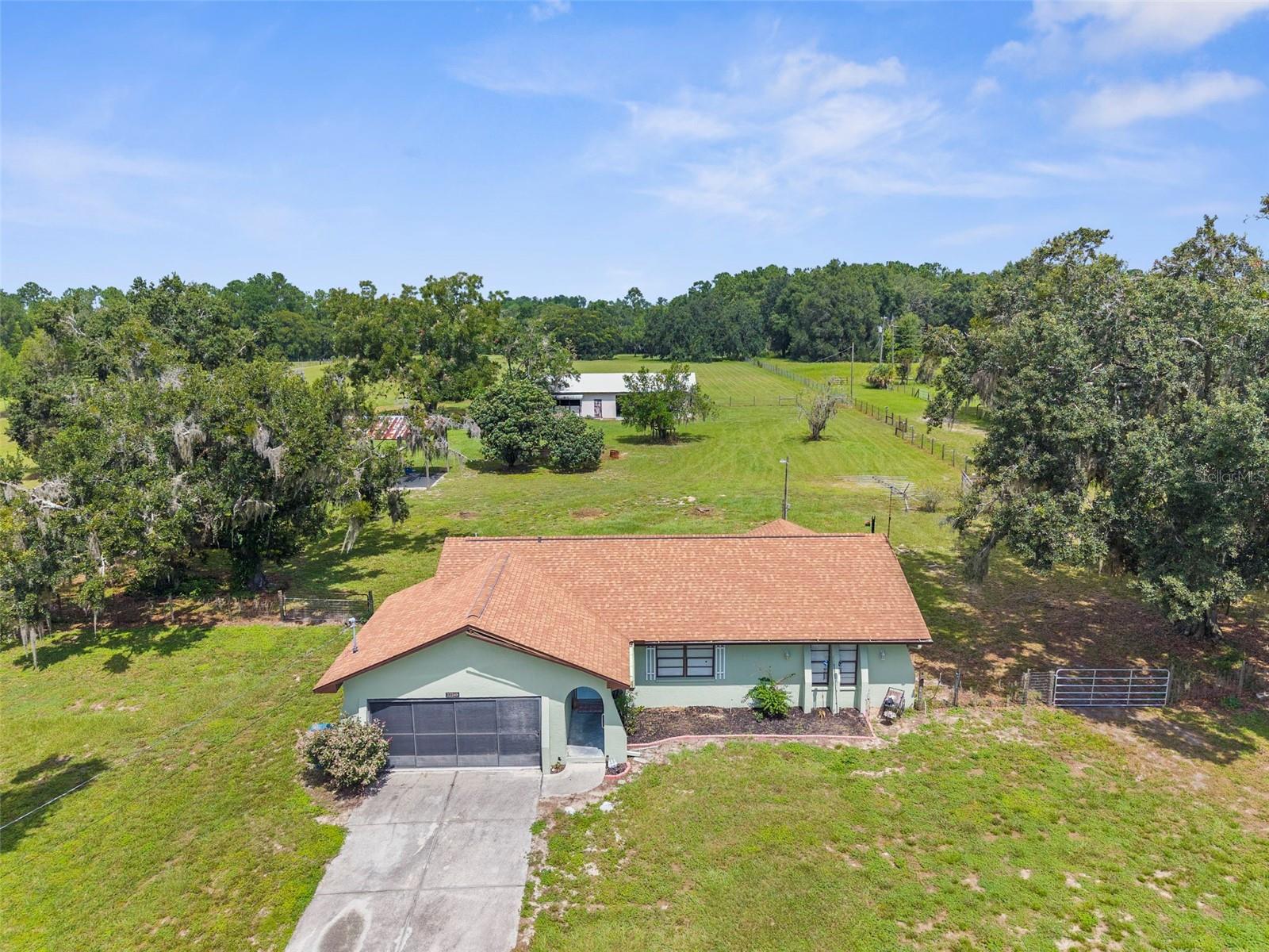 Discover the perfect blend of comfort and country living on this fully fenced 10-acre AG-zoned property. The 2-bedroom, 2-bath home offers 1,110 heated square feet and a total of 1,713 square feet under roof, providing a welcoming space with plenty of natural light and functionality.
A highlight of the property is the 1,120 sq. ft. detached garage, complete with 220 amp service—ideal for welding, a workshop, or heavy-duty projects. For equestrian enthusiasts, the property features a 5-stall horse stable and ample pasture, making it move-in ready for horses or livestock.
With wide-open acreage, secure fencing, and versatile outbuildings, this property is perfectly suited for hobby farming, equestrian pursuits, or building out your dream homestead.
Whether you’re seeking a peaceful retreat, a working farm, or simply extra space to spread out, this property offers unlimited potential.