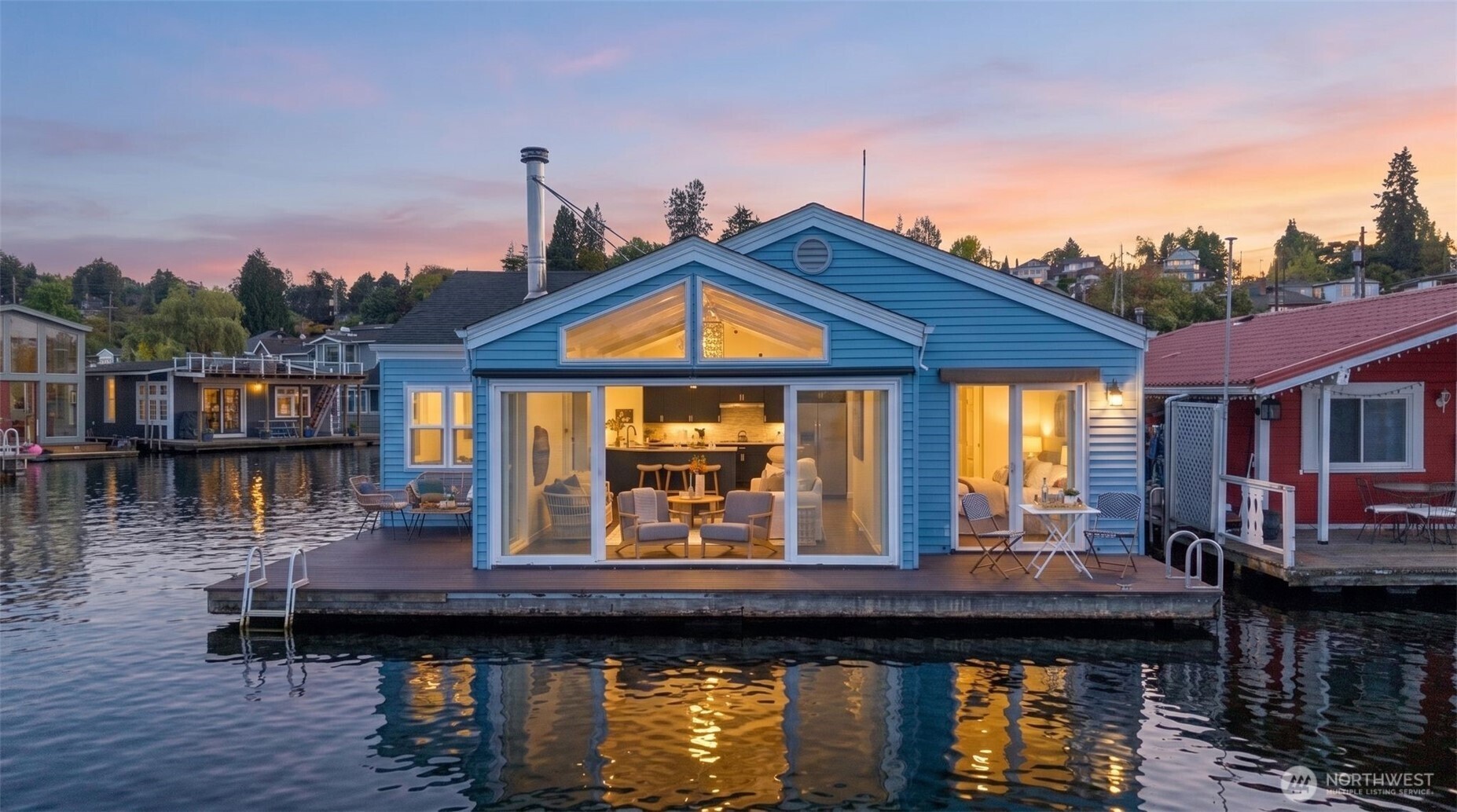 End-of-dock with uninterrupted views straight down the Montlake Cut, this rare front-row floating home offers the quintessential Seattle "houseboat" lifestyle. You own the moorage as a member of theco-op dock, complete with your own private boat slip, low-bank bulkhead waterfront, and two expansive decks designed for effortless outdoor entertaining, swimming, and launching your paddleboard. Inside, all-main-floor living features light-filled interiors, soaring vaulted ceilings, and gorgeous hardwood floors, all thoughtfully designed by architect Eric Hogeboom. The clever layout places the primary suite on its own with stunning water vistas and direct deck access, while two additional bedrooms sit on the opposite side of the home with dedicated bath space—all framed by brand-new windows ideal for taking in the summer boat parade or watching winter migratory birds. Freshly painted inside and out, packed with storage including an attic, and wrapped in panoramic views on three sides, this is an extraordinary opportunity to live right on the water.