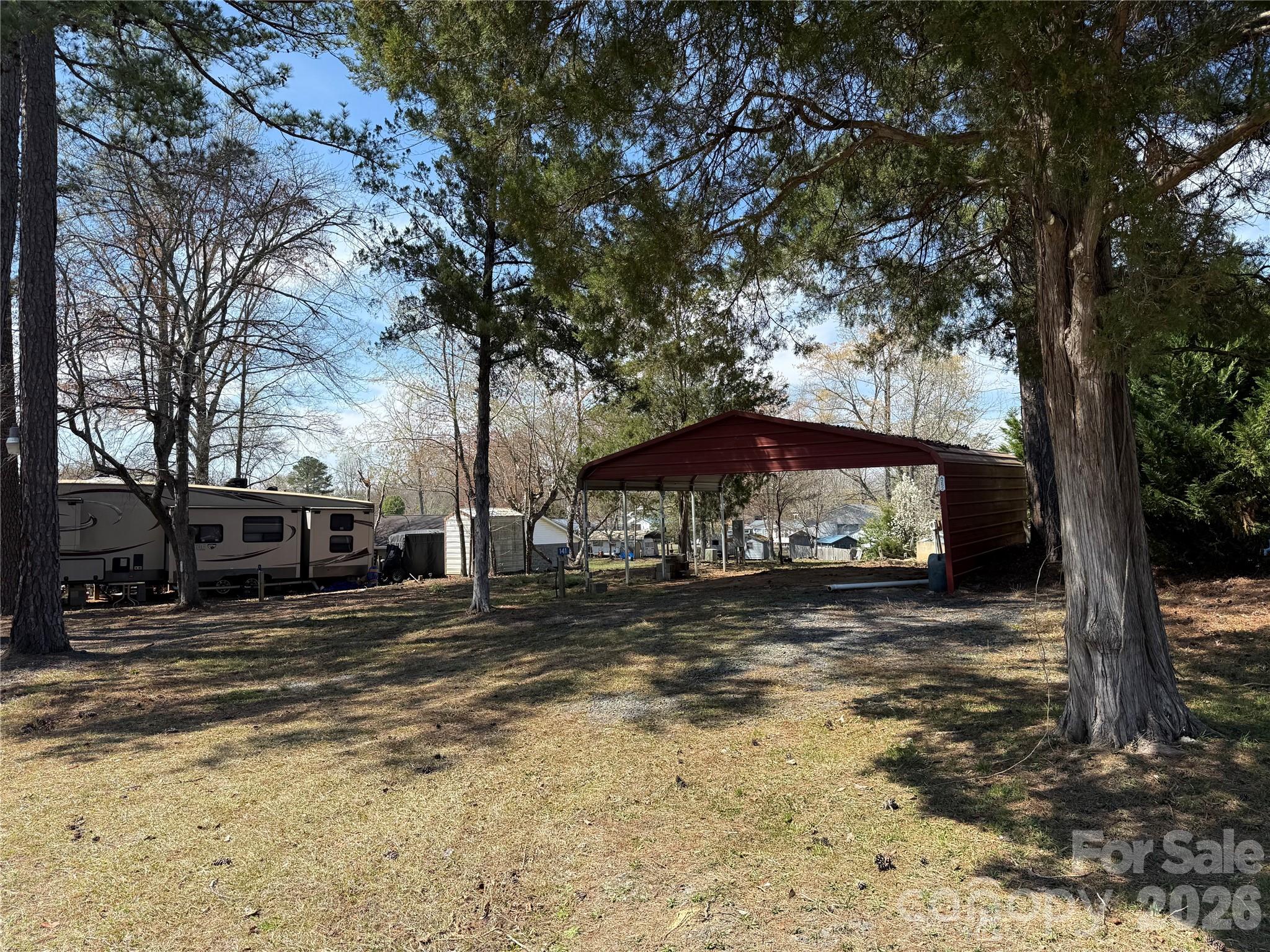 Two empty lots with a metal carport. Bring the camper you already love and set up shop for the season and seasons to come. Backs up to common area for privacy. These lots are close to the entrance for easy access to your place. Updated power to 200 amp. Water and sewer are ready to go. Come and see if this can be your "Happy Place" here in the park.All buyers must be with a realtor to gain access to the community.