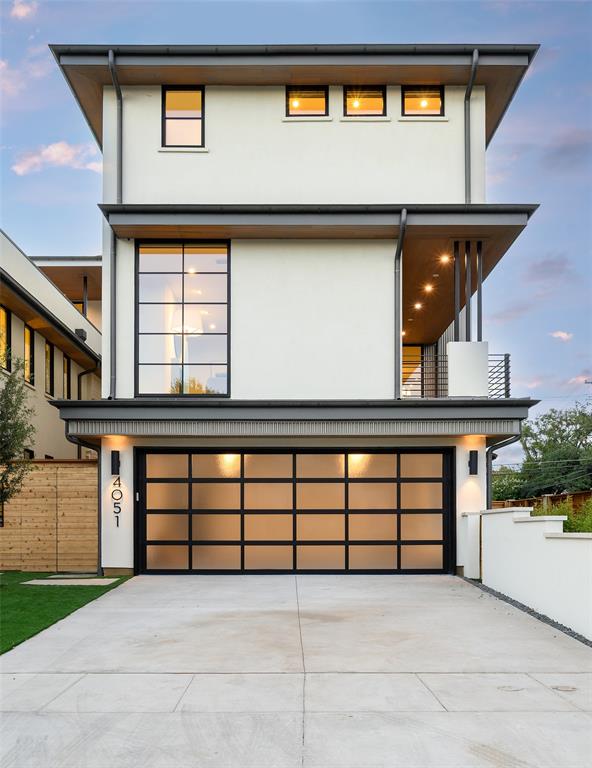 A bold architectural statement by Hudson Construction, 4051 Hawthorne Ave is an exceptional new construction residence just one block from Highland Park. Striking contemporary design, sophisticated interiors, and resort-inspired outdoor living come together beautifully throughout this impressive three-story home. The dramatic façade is defined by clean architectural lines, deep roof overhangs, warm wood soffits, expansive black-framed windows, and a sleek glass-paneled garage door. Inside, wide-plank hardwood floors, custom millwork, natural wood accents, dramatic stone selections, and walls of glass create a refined yet inviting atmosphere. An elevator provides convenient access to all three levels, while the open-concept floor plan is designed for effortless living and entertaining. Generous living and dining spaces flow seamlessly together, with oversized windows and doors creating a strong connection to the outdoors. The upper levels offer beautifully appointed private spaces with flexibility for guests, work, and entertaining. The third floor is a true standout, featuring an expansive living and entertaining retreat anchored by a showstopping custom wet bar with dramatic stone, fluted wood detailing, and extensive cabinetry. The private outdoor setting is equally impressive, with a sleek pool surrounded by landscaped green space creating a secluded urban retreat. Ideal for afternoons by the water, evening gatherings, or quiet weekends at home, the outdoor spaces complement the home's sophisticated architecture. Moments from Highland Park, Turtle Creek, Oak Lawn, and some of Dallas' premier shopping and dining, this newly constructed residence offers exceptional design, luxury finishes, and an enviable central Dallas location.