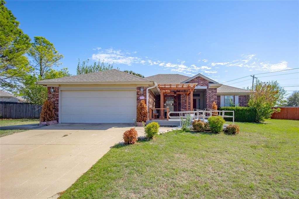 Awesome Norman Ranch offering single-level living at its finest. You'll love the large open kitchen and living area where a cozy fireplace becomes the heart of your home. The updated kitchen features granite counters and floor-to-ceiling cabinets extending down the wall, giving you storage space you never knew you needed. Wood-look tile flows throughout the entire home, so you can say goodbye to carpet forever. The thoughtfully designed Split bedroom plan gives everyone their own space. The primary suite has been beautifully remodeled with a roll-in shower and modified vanity for easy accessibility, plus there's a ramp to the front door. Step outside to your durable composite pergola and deck, perfect for watching Oklahoma sunsets. Nearly a quarter acre with a fenced yard, back patio, and storage shed means plenty of room to spread out. Two-car garage completes this move-in ready gem.