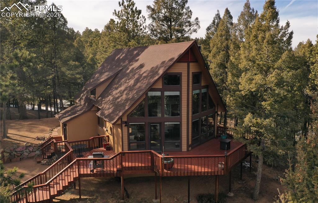 Better than new! This stunning 2,638 SF mountain sanctuary was fully reimagined with high-end finishes and major infrastructure updates in 2024 and 2025. Set on 4.35 private, wooded acres of pines and aspen groves, this property offers ultimate privacy and frequent visits from moose, deer, and fox.The interior is anchored by a breathtaking two-story living room featuring floor-to-ceiling windows, vaulted wood ceilings, and premium white oak flooring. A high-efficiency Lopi wood stove with a stone hearth creates a cozy centerpiece, while large glass doors lead to an expansive wrap-around deck. The 2024 remodeled chef’s kitchen boasts sleek quartz countertops, stainless appliances (including induction and convection cooking), and white oak floors.The upper-level Master Suite is a private retreat with vaulted ceilings and a spa-like bath featuring unique circular ceramic tile and a walk-in shower. An adjacent loft family room overlooks the living area, providing a perfect secondary lounge with sweeping mountain and forest views. The main level offers two additional bedrooms with new Berber carpet and a fully remodeled full bath with hexagonal ceramic tile.The garden-level lower floor adds incredible versatility with a workout room/office/non-conforming 4th bedroom, a bonus room, and a large laundry/mechanical area. Hobbyists will love the oversized garage featuring a significant dedicated shop area, plus an additional storage building on-site. RV? No problem with a dedicated site with elec.Major upgrades provide total peace of mind: Class 4 Roof (2024), 200-Amp Electrical Service (2022), New Furnace (2022), New Water Heater (2025), and siding/paint. Located in a recreational paradise, you are minutes from gold medal fishing, hiking, and OHV trails. Experience modern luxury in a classic Colorado setting.