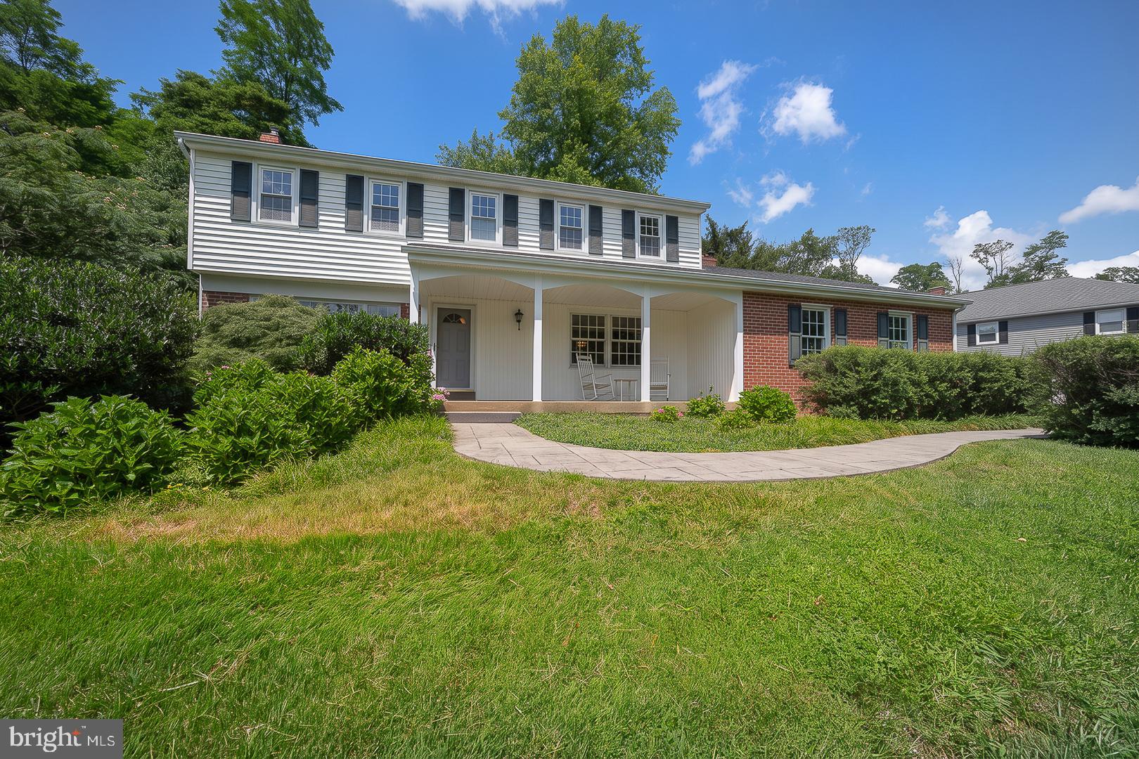 Welcome to this beautifully maintained 4-bedroom, 2½-bath Colonial with an impressive family room addition, expanded kitchen, and quality updates throughout. A covered front porch sets the stage for the warm and inviting interior, where hardwood flooring extends throughout the home. The formal living room opens to the rear patio through sliding glass doors, creating a seamless connection to outdoor living, while the formal dining room with chair rail provides an elegant setting for entertaining. At the heart of the home is the expanded kitchen, thoughtfully designed for both everyday living and the home chef, featuring stainless steel appliances, Corian countertops with matching backsplash, under-cabinet lighting, a built-in dishwasher, garbage disposal, and a premium dual-fuel range with a 6-burner gas cooktop and electric oven. The adjoining breakfast area flows into the impressive family room addition, highlighted by a soaring cathedral ceiling with exposed beams, recessed lighting, custom built-in cabinetry, ceiling fan, and a raised-hearth brick fireplace, creating an inviting gathering space for family and friends. The main level also includes an updated powder room with marble tile flooring, pedestal sink, and mirrored medicine cabinet, along with a full-size laundry room offering abundant cabinetry and storage. Upstairs, the spacious primary suite features a ceiling fan and an updated ensuite bath with ceramic tile flooring, pedestal sink, and a tiled shower. Three additional generously sized bedrooms, including one with custom built-in cabinetry, are served by an updated ceramic tile hall bath with vanity, mirrored medicine cabinet, and ceramic tile tub/shower, while two hallway linen closets provide exceptional organization. Complete with a 2-car side-load garage with automatic garage door opener and an unfinished basement offering excellent storage and future finishing potential, this home provides both convenience and flexibility. Additional improvements include a high-efficiency HVAC system and gas hot water heater. Outside, the large patio provides the perfect setting for summer barbecues, outdoor dining, and relaxing with family and friends. Combining classic Colonial appeal with modern updates, spacious living areas, and an exceptional layout designed for today’s lifestyle, this wonderful home offers an outstanding opportunity. Schedule your private showing today and discover all it has to offer.
