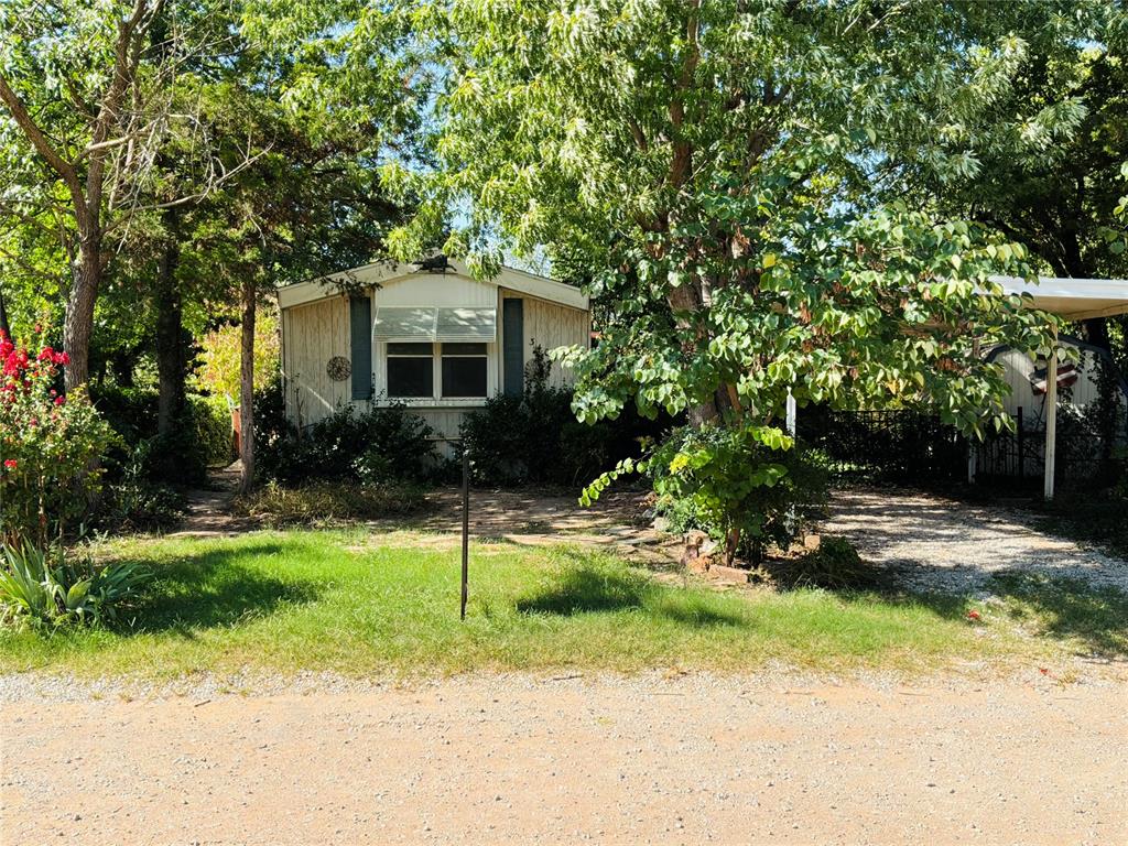 This is a single wide 2001 Mobile Home. It offers 3 bedrooms, 2 baths, Kitchen, Dining area and Laundry Room. It has two out buildings(storage sheds), a detached 2 car garage and a Carport. The garage and sheds will either need a good amount of work or be tore down, the car port is in satisfactory condition but the garage will likely need a new roof and new siding.The home itself will need a good amount of TLC. Would make a great investment property!