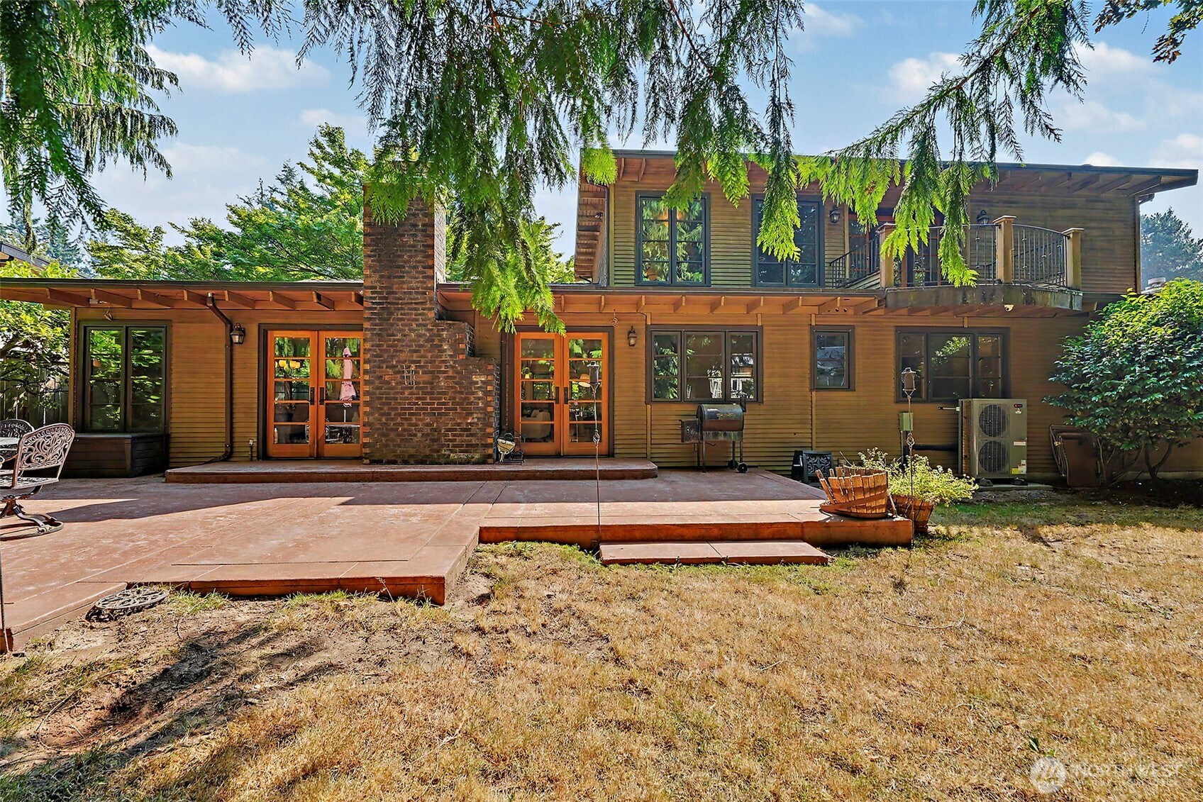 Welcome to a truly one-of-a-kind home in Kirkland’s desirable Rose Hill neighborhood! Thoughtfully remodeled with warmth, character and custom details throughout, this 4-bedroom home is anything but cookie-cutter. The heart of the home is the expansive chef’s kitchen featuring a professional-style range, generous cabinetry, farmhouse sink, stone counters and an impressive oversized island/bar with seating for six. Arched openings connect the kitchen to spacious living and dining areas, where rich hardwood floors, custom built-ins and a brick fireplace create an inviting place to gather. Multiple French doors and abundant windows bring in natural light and open to outdoor living spaces surrounded by mature greenery. A dedicated office with built-in desk and cabinetry makes working from home easy. Flexible bedroom layout includes an upstairs primary suite plus a second ensuite downstairs—ideal for guests, extended living or added privacy—along with two additional bedrooms and a hall bath. Convenient laundry with utility sink and storage. Don't miss the spacious carriage-style detached garage with attic storage and four full size doors. A distinctive Rose Hill home filled with craftsmanship, charm and spaces designed for everyday living and entertaining.
