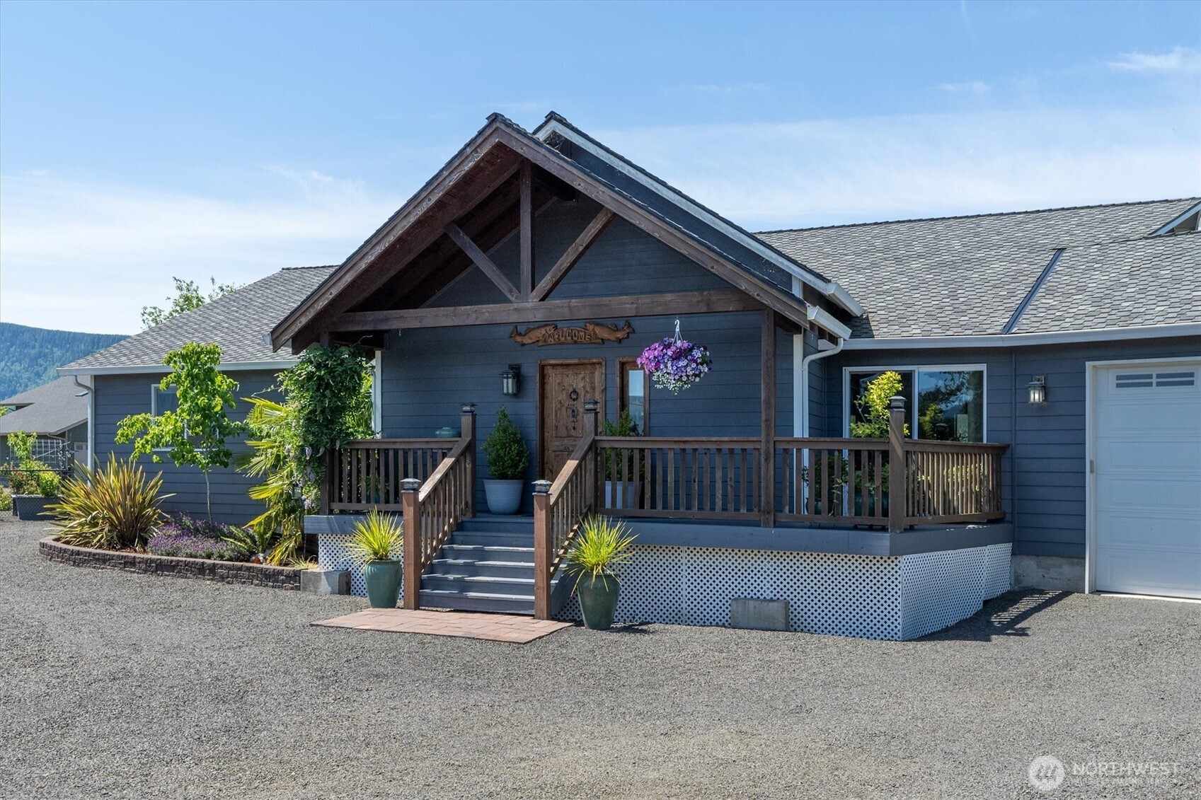 Custom-built and meticulously maintained, this 2,169 sq ft home on 1.2 acres offers stunning views overlooking Welcome Slough and the Columbia River. Built in 2013, the home features 2 designated bedrooms, 2 baths, and a versatile bonus room that could serve as a family room or a non-conforming third bedroom. Quality finishes include porcelain tile flooring, quarter-sawn oak soft-close cabinetry, granite countertops, zebra marble in the primary bath, and a spacious walk-in pantry. The primary suite is a true retreat, featuring a custom walk-in shower with waterfall shower head and direct access to the expansive deck. Floor-to-ceiling windows in the living room frame breathtaking water views, creating a stunning backdrop for everyday living. Step outside to enjoy the peaceful setting from the full-length deck, gather around the fire pit, tend the fenced garden area complete with pergola and seating space, or simply watch ships pass by while local wildlife enjoys the calm waters of Welcome Slough. An oversized finished garage and a 36-foot-deep shop with a 14-foot door provide exceptional storage, including room for a full-size RV. The property includes one designated full RV hookup with the infrastructure for a second. For waterfront enthusiasts, explore the possibility of repurposing the existing pilings in the slough for a future dock. A rare opportunity to enjoy custom craftsmanship, incredible views, and a quieter pace of life in a truly remarkable waterfront setting.