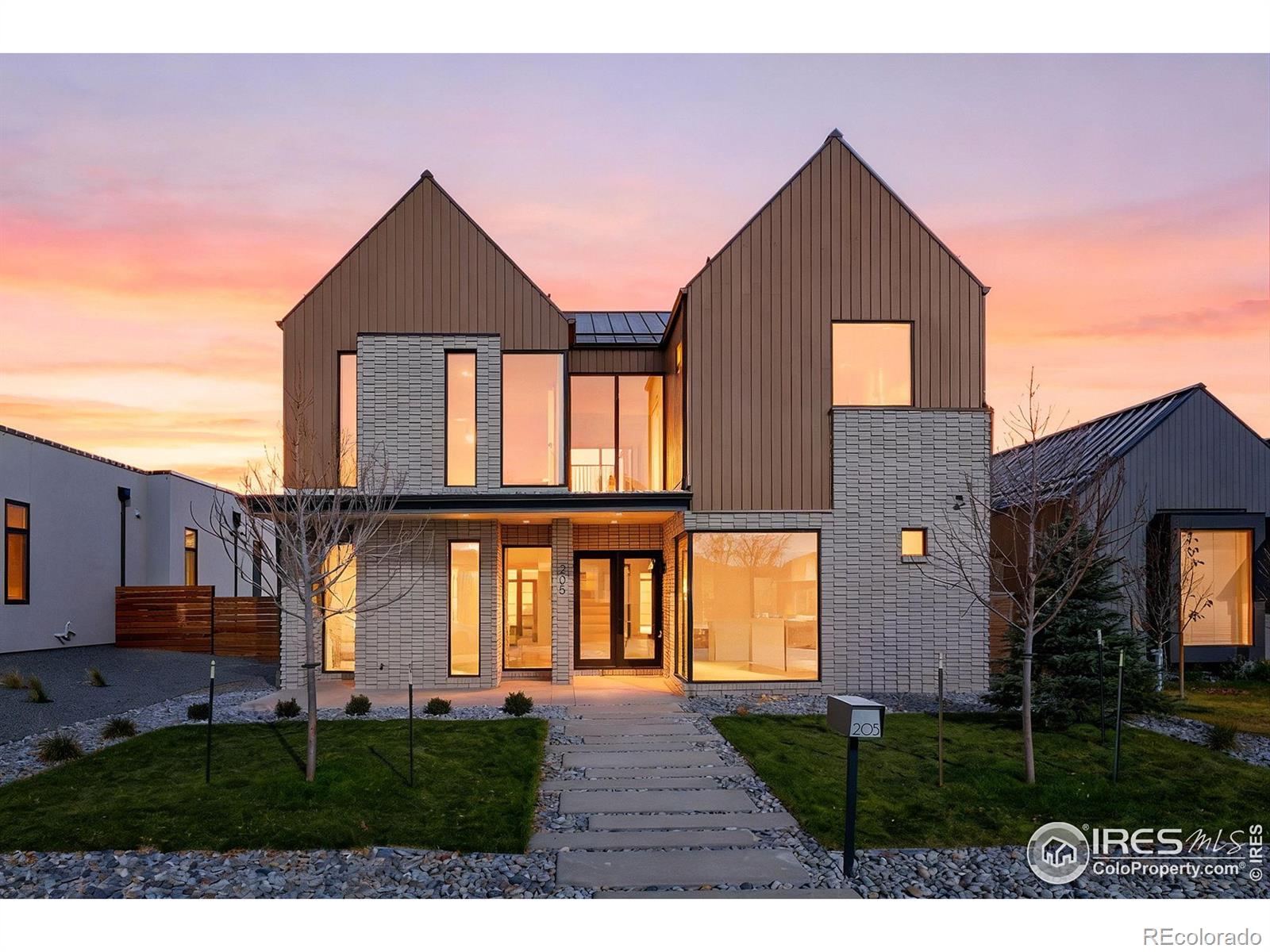 A rare opportunity to own one of Original Town Superior's most extraordinary new builds-where architectural design, premium brands, and curated luxury come together at a level seldom seen. Sierra Pacific aluminum-clad wood windows and Windsor premium doors fill the home with natural light, illuminating expansive white oak flooring and a bright, modern layout. Floor-to-ceiling glazing and Windsor French doors open to a covered patio for true indoor/outdoor living, centered around a striking stone fireplace with custom floating hearth. At the heart of the home, the chef's kitchen features Benedettini custom walnut cabinetry, warm-veined quartz countertops, a dramatic waterfall island, and GE Monogram professional appliances, including column refrigerator and freezer. A Brizo faucet, Blanco sink, custom hood, and sculptural lighting elevate the space. The primary suite is a serene retreat with vaulted ceilings and mountain views. Its spa-inspired bath is wrapped in honed Calacatta porcelain tile and includes floating Benedettini walnut cabinetry, Brizo fixtures, undermount sinks, and a zero-entry shower with Brizo rain head and euro-glass enclosure. A boutique-style Benedettini closet offers exceptional storage and elegance. Secondary bedrooms are unusually large with tall ceilings, complemented by a terrazzo-clad secondary bath with leathered soapstone, a sculptural powder room, a custom mudroom with walnut slat wall, and a modern laundry room. EnergyStar rated, the home offers dual furnaces and A/C units with Ecobee thermostats, a tankless water heater with recirculation, and a mini-split for the garage flex space-perfect for an office, gym, or studio.All of this sits steps from the Marshall, Colton, and Coal Creek trail systems and moments from Target, Costco, Whole Foods, restaurants, and fitness. A dramatic fusion of luxury, design, and location-homes like this rarely come along. Builder preferred lending incentive available!