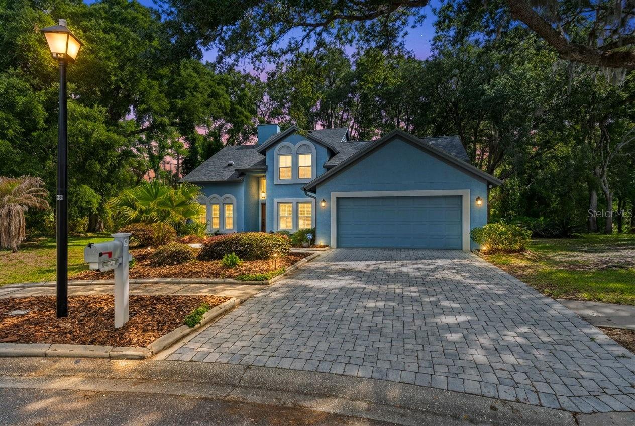 Lives like a house, feels like a cottage. Centrally located in the heart of Tampa Palms on a quiet cul-de-sac, this rare find overlooks a serene backdrop of stately oaks and tropical palms.Boasting 4 bedrooms, a private office, 2.5 bathrooms, a pool, and a 2-car garage, this home offers upgrades that will impress even the most discerning buyer. Beautiful landscaping, along with a pavered driveway and walkway, creates a welcoming first impression as you approach the front entrance.A grand two-story foyer opens to the formal dining room, featuring lush wood plank flooring, new windows, and plantation shutters. The wood flooring flows throughout most of the first floor, including the spacious great room, where a cozy fireplace and picturesque views of the pool and conservation setting create the perfect gathering space.Just off the great room, the seller has added a versatile bonus room that can be used as an office, playroom, or exercise space. The kitchen is generously sized and updated with 42-inch maple cabinetry, granite countertops, and stainless steel appliances.The primary suite is conveniently located on the first floor, along with a guest bedroom and half bath. Upstairs, you’ll find two additional bedrooms and a full bathroom, offering privacy and flexibility for family or guests.Step outside and enjoy the Florida lifestyle at its finest. The oversized pool area features a pavered deck, a newer re-screened enclosure, and overlooks a large, private backyard with tranquil conservation views.Located just minutes from top medical facilities including Moffitt Cancer Center, USF, the VA Hospital, and AdventHealth, as well as premier shopping at Wiregrass Mall and Tampa Premium Outlets, fine dining, and top-rated schools, this home offers the perfect blend of comfort, convenience, and lifestyle.