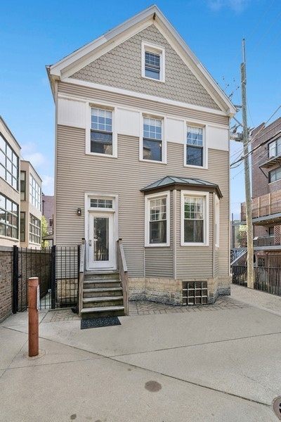 Rarely available and truly one-of-a-kind, this spacious Coach House in the heart of East Lakeview offers the feel of a single-family home in one of Chicago's most desirable neighborhoods. Tucked away on a quiet, tree-lined street, this standalone residence features approximately 2,500 square feet across three levels, with low HOA dues of just $185/month and one exterior parking spot included in the price. The main level welcomes you with a generous, open layout including a large living room, dining area, kitchen, and powder room. Just off the dining space, step out onto a small private deck-ideal for grilling, morning coffee, or winding down at the end of the day. The second level offers two oversized bedrooms, a full hallway bathroom, and a laundry room. One of the bedrooms opens onto its own private outdoor deck-a sunny, serene escape perfect for lounging with a book, a glass of wine, or enjoying a peaceful start to your morning. The third floor is dedicated to a private primary suite featuring two large walk-in closets, a spacious bathroom with jetted tub and separate shower, and an expansive deck-your own private retreat in the city. This exceptional Coach House offers a rare combination of space, privacy, and location-providing a spacious canvas ready for your personal style and creativity. Whether you're looking to move right in or customize over time, the possibilities are endless. Located in the coveted Nettlehorst School District and just steps from the lakefront, Wrigley Field, public transportation, and all the shops, dining, and nightlife of East Lakeview-this home is city living at its finest.