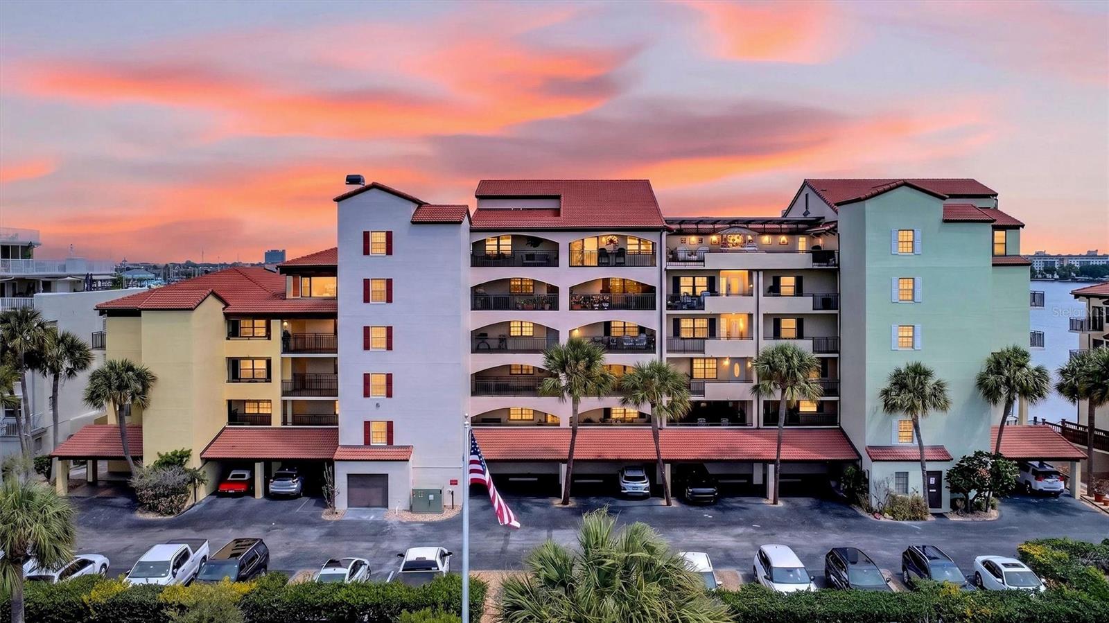 A rare Intracoastal Waterway frontage penthouse offering nearly 3,000 square feet of refined, fully renovated living with water views from every room. One of only four penthouse residences within the gated Marina Point community, this extraordinary two-story residence sits on a private peninsula surrounded by marinas, passing yachts, dolphins, manatees, and endless waterfront activity. Completely reimagined in 2022 with a refined waterfront-modern aesthetic, the home blends sleek contemporary finishes with warm architectural details designed to complement the views rather than compete with them. Wide-plank LVP flooring, shiplap ceilings with architectural wood beams, and expansive walls of new floor-to-ceiling impact glass create a home that feels sophisticated, open, and deeply connected to the water. The kitchen was designed for both everyday living and entertaining, centered around a dramatic one-piece quartz waterfall island and complemented by premium appliances, dual dishwashers including a bar dishwasher, ice maker, microwave drawer, large wine and beverage coolers, and a custom wet bar with designer tile and cabinetry. An electric fireplace anchors the main living space, adding warmth and ambiance. Floor-to-ceiling windows frame beautiful north and south Intracoastal views, along with striking views of the bridge, seasonal fireworks, and the Christmas boat parade. The primary suite features a riverfront sunroom wrapped in glass and a spacious custom walk-in closet. The upper-level functions as a private guest retreat with its own bedroom, full bath, and loft-style sitting area. Multiple waterfront terraces create outdoor living spaces rarely found in condominium residences. Includes four assigned parking spaces, two secured underground and two private carport spaces with EV charging connected directly to the unit’s electrical panel. Abundant interior and exterior storage, including garage storage. The community has recently completed a $4M restoration and modernization project with all assessments fully paid by the sellers. Boat slips are available, and Ponce Inlet is approximately 25 minutes away by boat. Ideally located near the Riverfront Esplanade, Chart House, Halifax River Yacht Club, downtown Daytona Beach, parks, marinas, shopping, dining, and entertainment. A truly rare opportunity to own a move-in ready penthouse with exceptional space, views, and waterfront lifestyle.