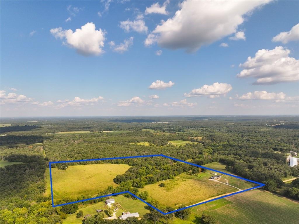 Home For Sale Cedar County, MOEscape to the beauty of the Missouri countryside with this stunning newer home situated on 35± acres in Cedar County, just outside El Dorado Springs, MO. Offering approximately 2,400 square feet of thoughtfully designed living space, this 4-bedroom, 3-bathroom home combines modern amenities with the privacy and freedom that only acreage can provide. Whether you're searching for a family home, hobby farm, or peaceful country retreat, this property offers endless possibilities.The spacious open floor plan welcomes you with durable laminate flooring and a warm propane fireplace that creates the perfect centerpiece for relaxing evenings or entertaining guests. The kitchen is designed for both function and style, featuring stainless steel appliances, including a double oven range, microwave, dishwasher, and refrigerator, giving you everything needed to prepare meals for family gatherings or holiday celebrations. A large utility room provides abundant storage, workspace, and everyday convenience.Built with attractive board and batten siding and topped with a durable shingle roof, the home offers timeless curb appeal and low-maintenance living. A covered carport provides protection for your vehicles, while additional parking leaves plenty of room for trailers, RVs, equipment, or guests. The owned propane tank is another valuable feature that helps reduce long-term ownership costs.The 35± acres surrounding the home offer room to make your dreams a reality. Whether you envision raising livestock, keeping horses, establishing a hobby farm, planting a large garden, or simply enjoying the peace and privacy of rural Missouri, this property provides the space to do it all. Wildlife is abundant throughout Cedar County, making the acreage attractive for outdoor enthusiasts who enjoy watching deer and turkey or exploring their own land.
